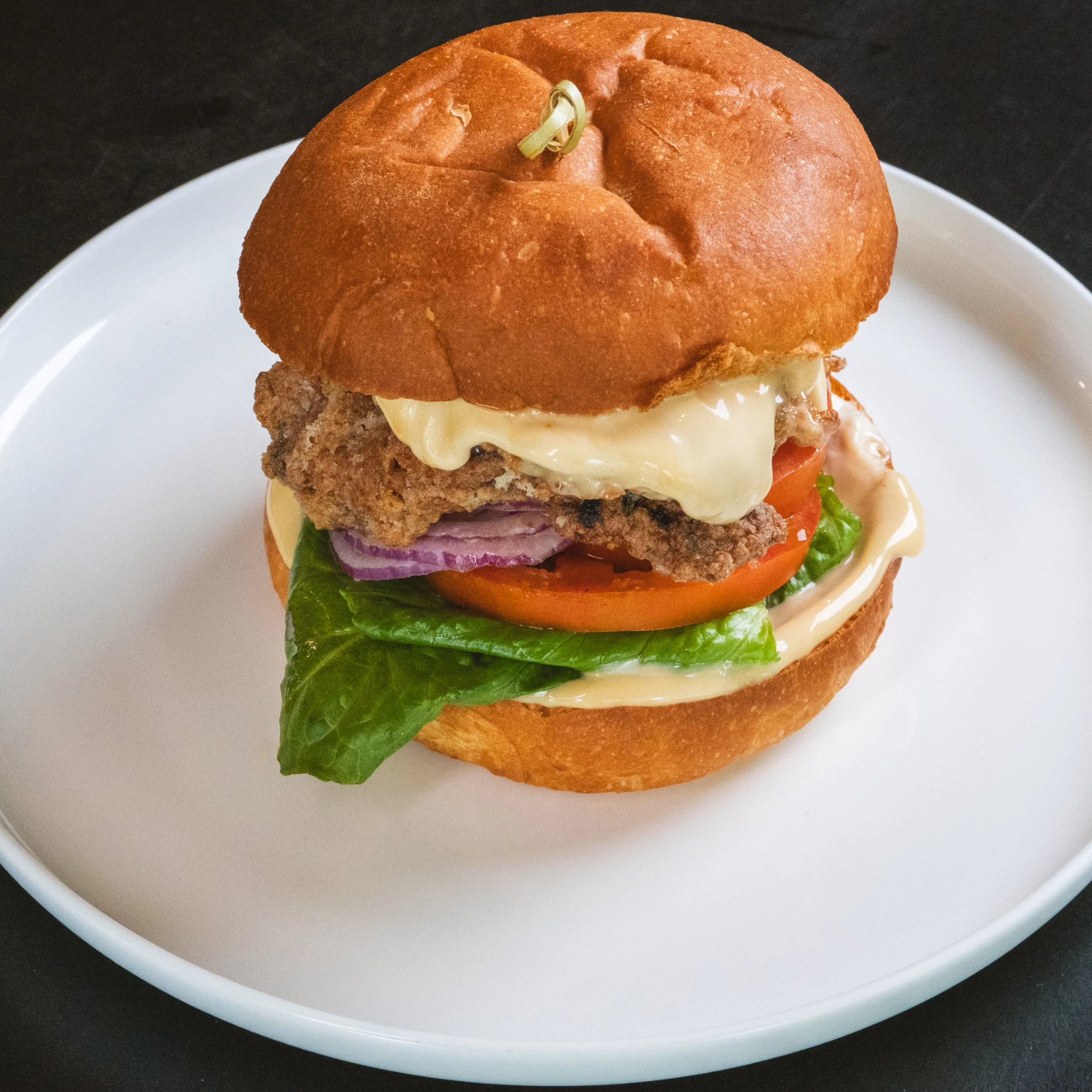 Crispy chicken burger with lettuce and sauce at ALL DAY café in West End Brisbane
