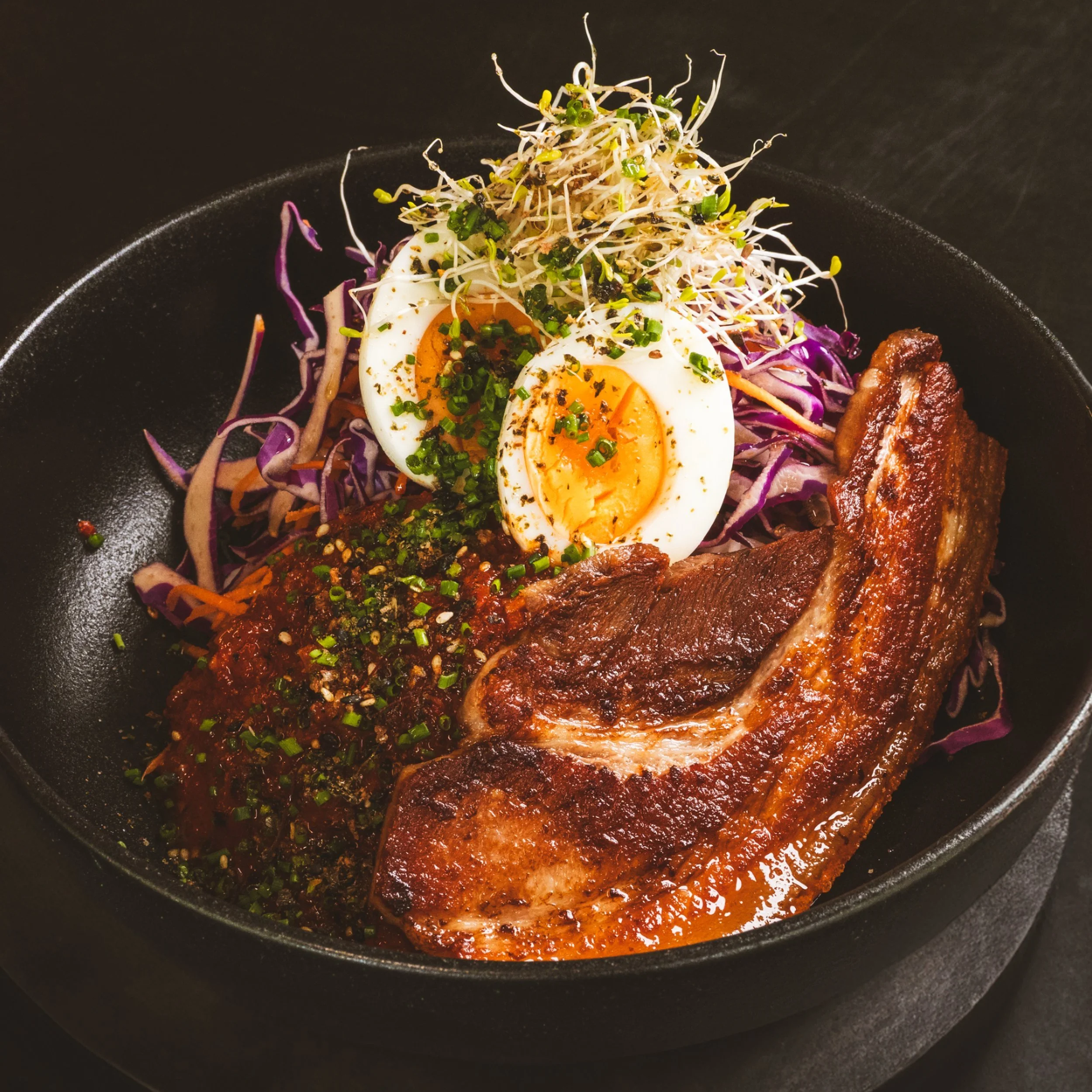 Crispy pork belly bowl with vegetables and sauce at ALL DAY café in West End Brisbane