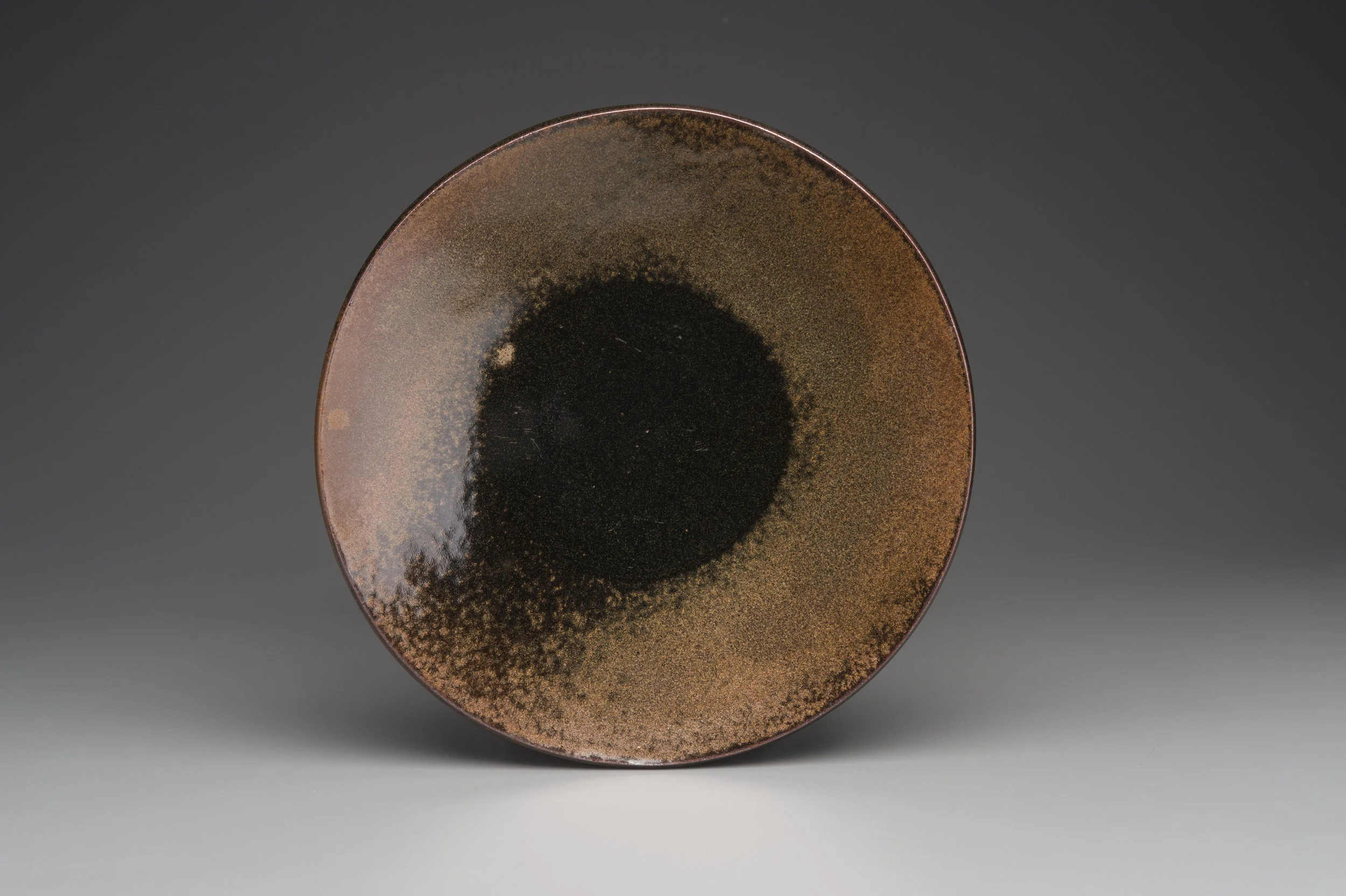 Stoneware charger with temmoku and rutile glaze, Reduction.