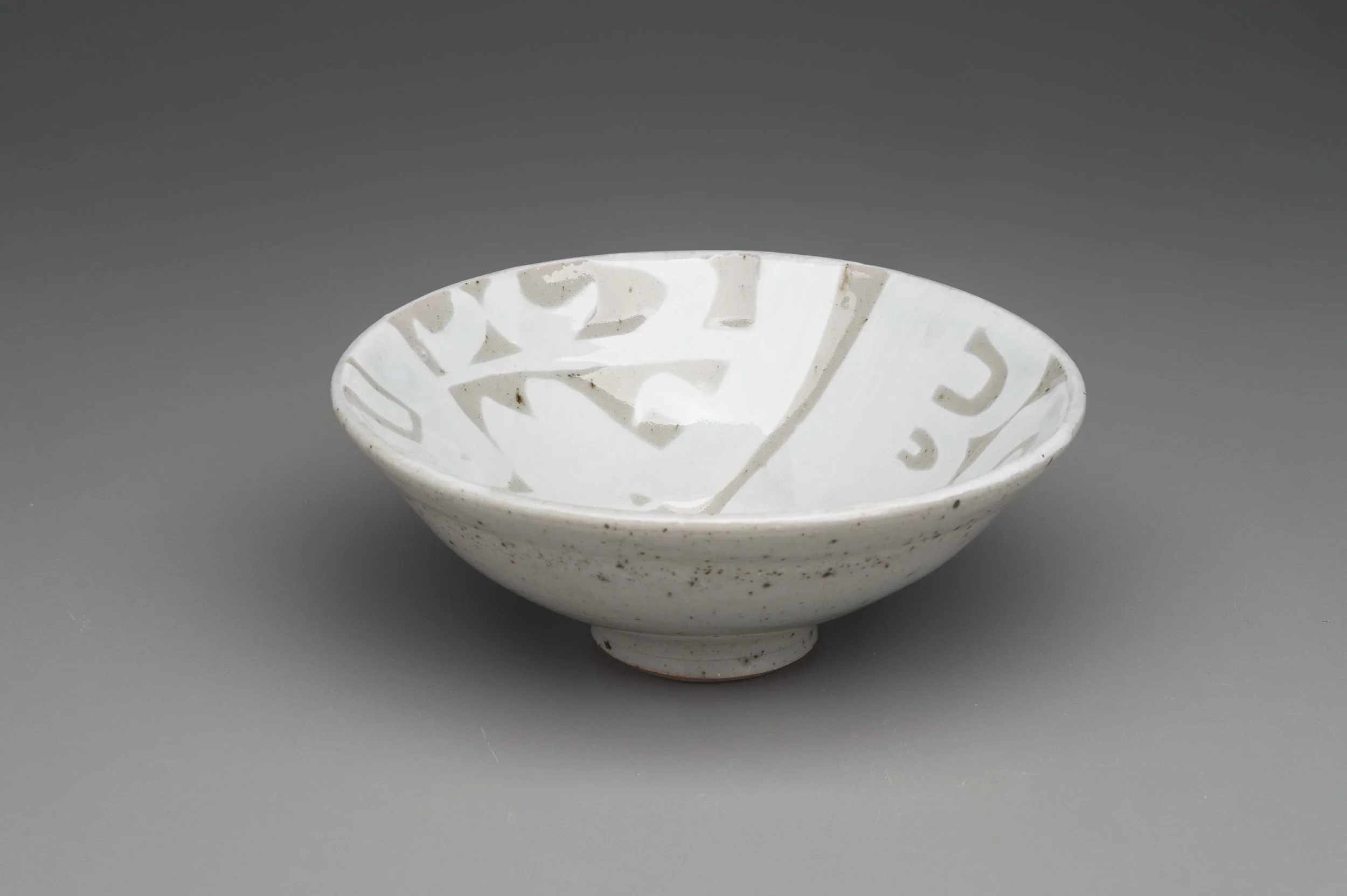Stoneware and porcelain water etched bowl with celadon glaze.