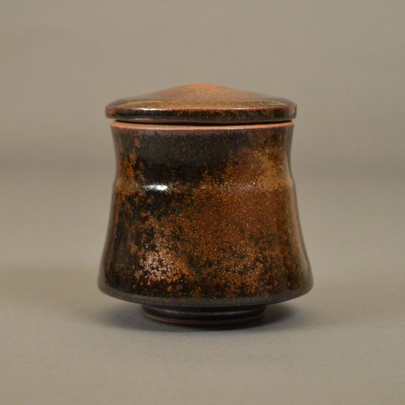  Small stoneware jar with temmoku and rutile glazes. &nbsp;Reduction cone 6-8 