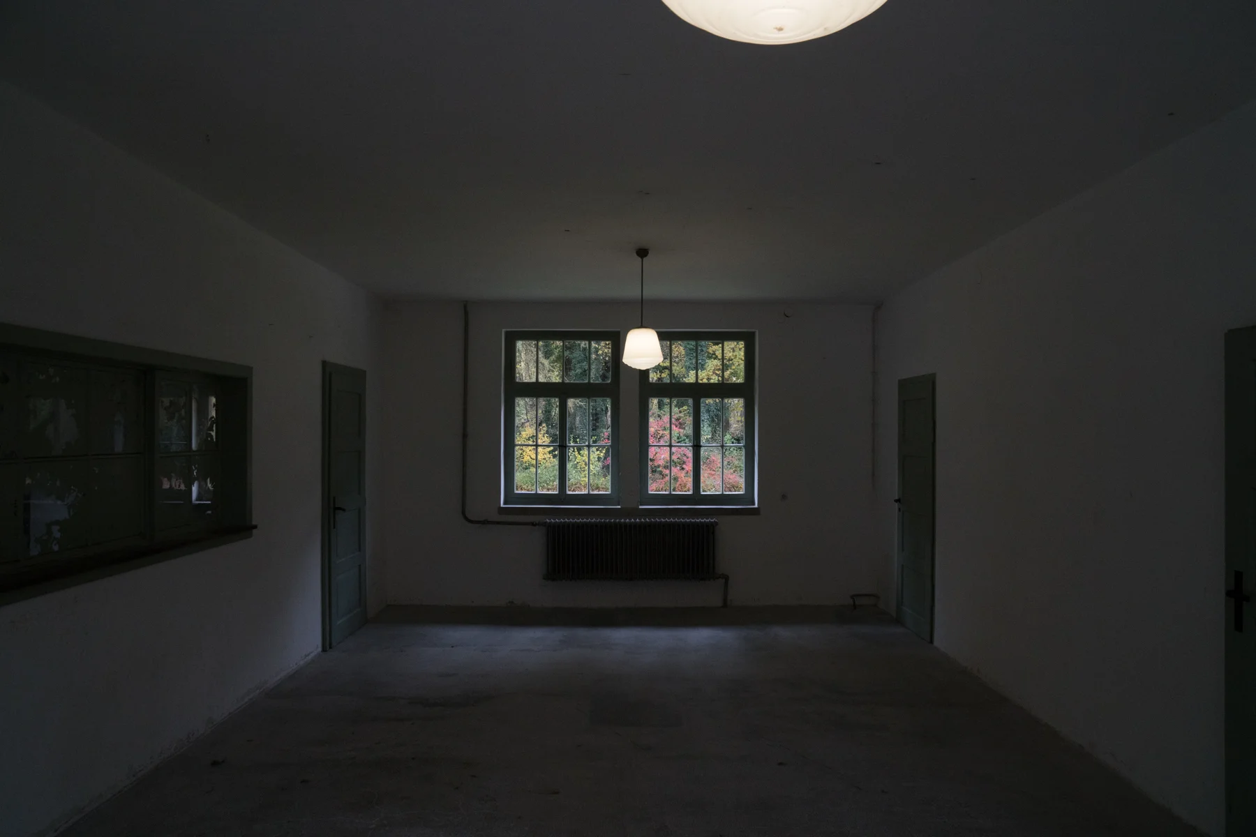 herbsttaken at the dachau concentration camp in germany. beautiful &amp; vibrant autumn colors seep through the window, contrasting the otherwise gray room.&nbsp; &nbsp; &nbsp; &nbsp; &nbsp; &nbsp; &nbsp; &nbsp; &nbsp; &nbsp; &nbsp; &nbsp; &nbsp; &n…