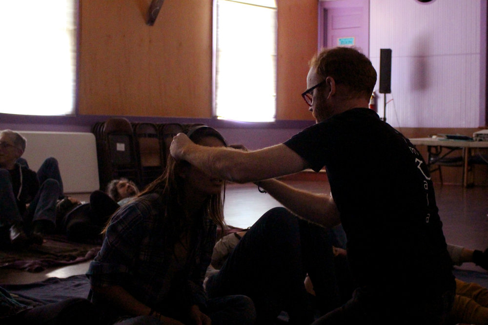 Mentor Jermey McKane fits a neuro feedback machine to a fellows head