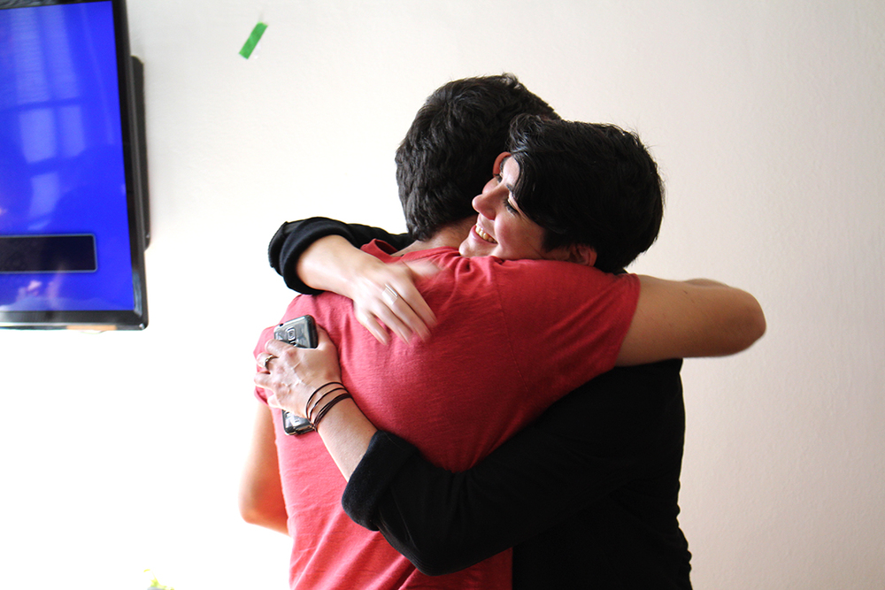 Leyla shares a congratulatory hug with Murillo, one of the fellows on the winning team