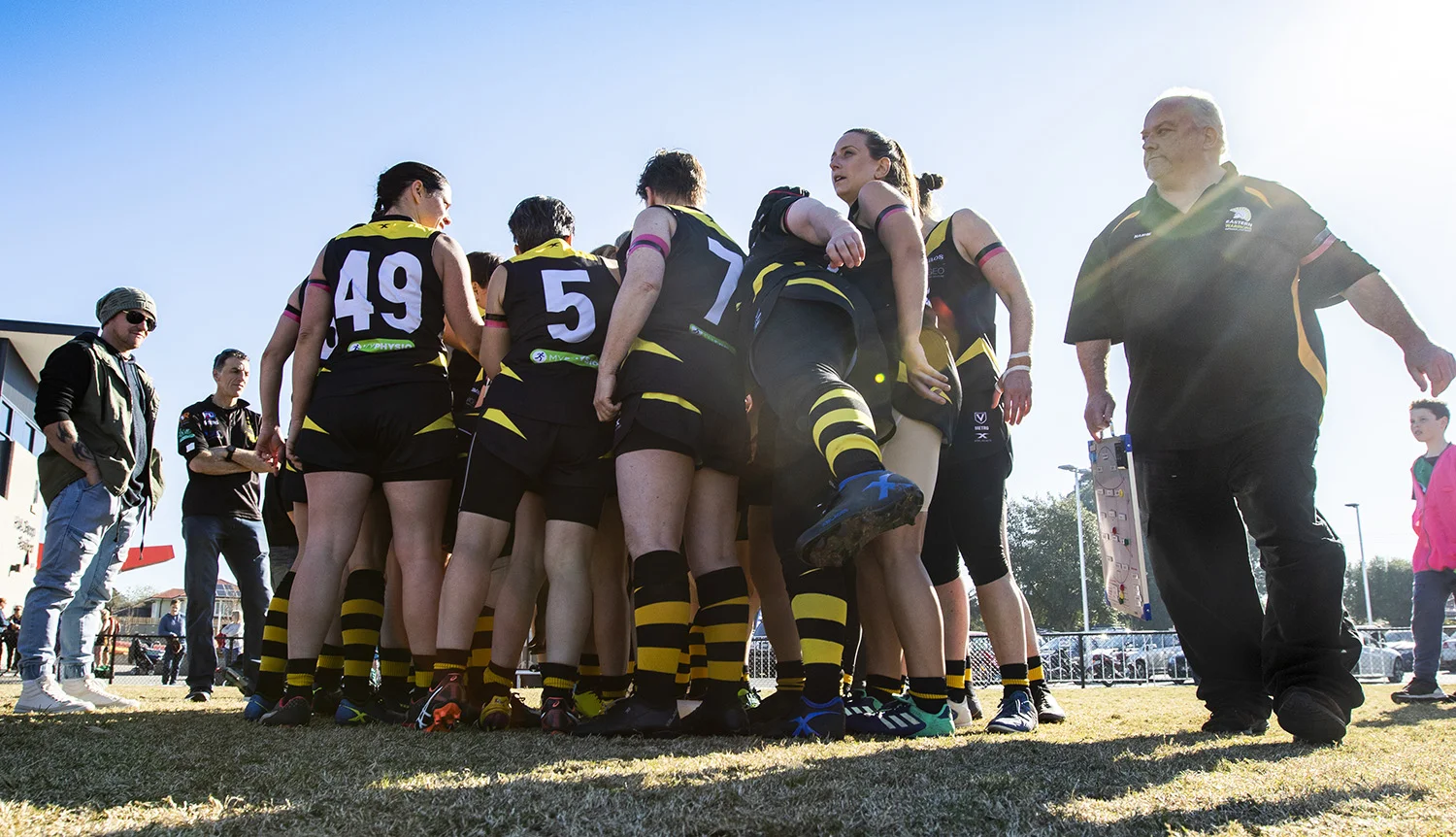 Final huddle at the last game of the season. Throughout the year the women developed strong bonds and Nash says they often resolved issues within the team without his input.