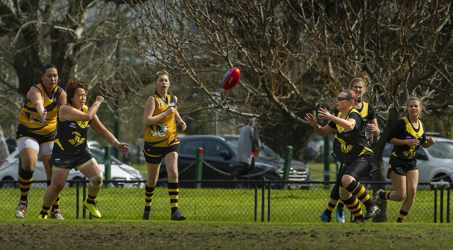 Loh shoots a handball out to a teammate. From a low base, with Loh acting as one of the few experienced players in the team, the skills of others improved significantly.