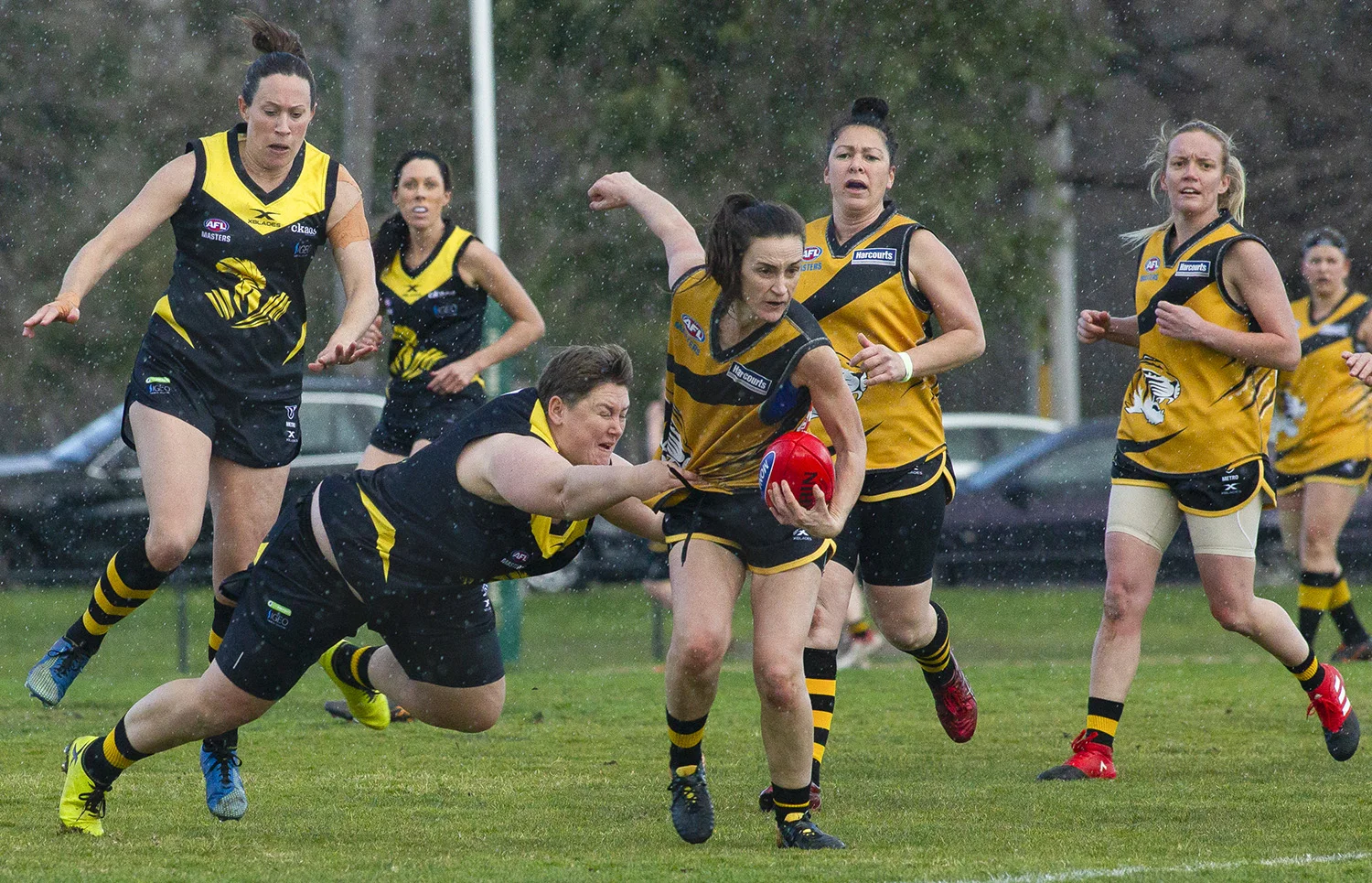 The players may be a little older, but the passion to play is evident. Beventyre lays a tackle on a wet and wild day where the Warriors were trounced. It made no difference to the effort!