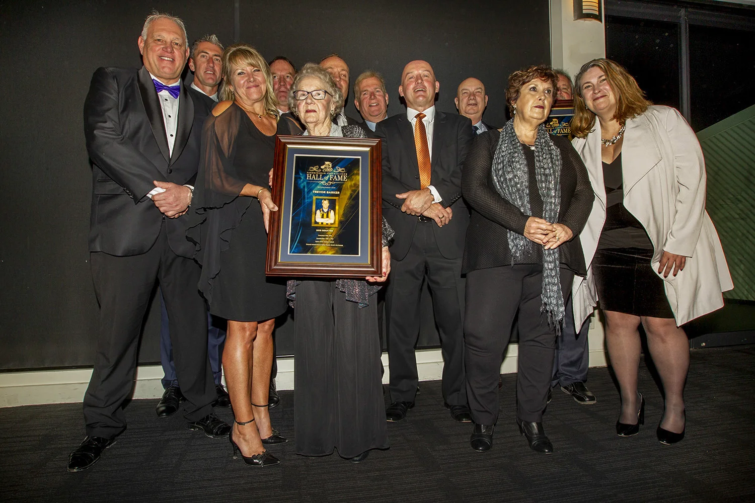 Fellow inductees were part of a gala dinner and social event, where late Sandringham and St.Kilda clubs great Trevor Barker was honoured with the presence of his mother Norma (holding his framed award). Crough is second from left at rear.