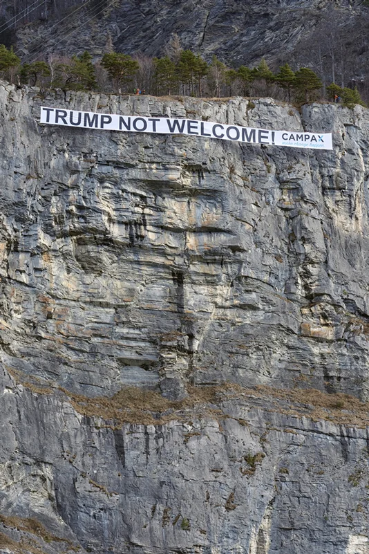 Campax protestiert in Sargans gegen Trump-Besuch. Donald Trump will noch im Januar zum WEF in Davos reisen und dort seine Politik "America First" erklären und verteidigen. Müsste es nicht "The World First" heissen? Eine Politik, die nur auf Eigennutz, Wachstum und Machtzuwachs gründet, führt weder zu Wohlstand noch zu Frieden. Die Gruppe Campax hat am Donnerstagmorgen mit einer ungewöhnlichen Aktion gegen die Teilnahme von US-Präsident Donald Trump am WEF in Davos protestiert. Kletterinnen und Kletterer hängten ein 60 Meter langes Anti-Trump-Transparent in eine Felswand bei Sargans SG Bild: Antonino Panté / Keystone / AP / sda