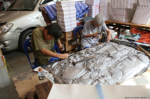father (right) and son (left) working on a piece together