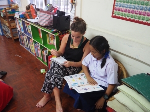 One of the volunteers helping a student with her work