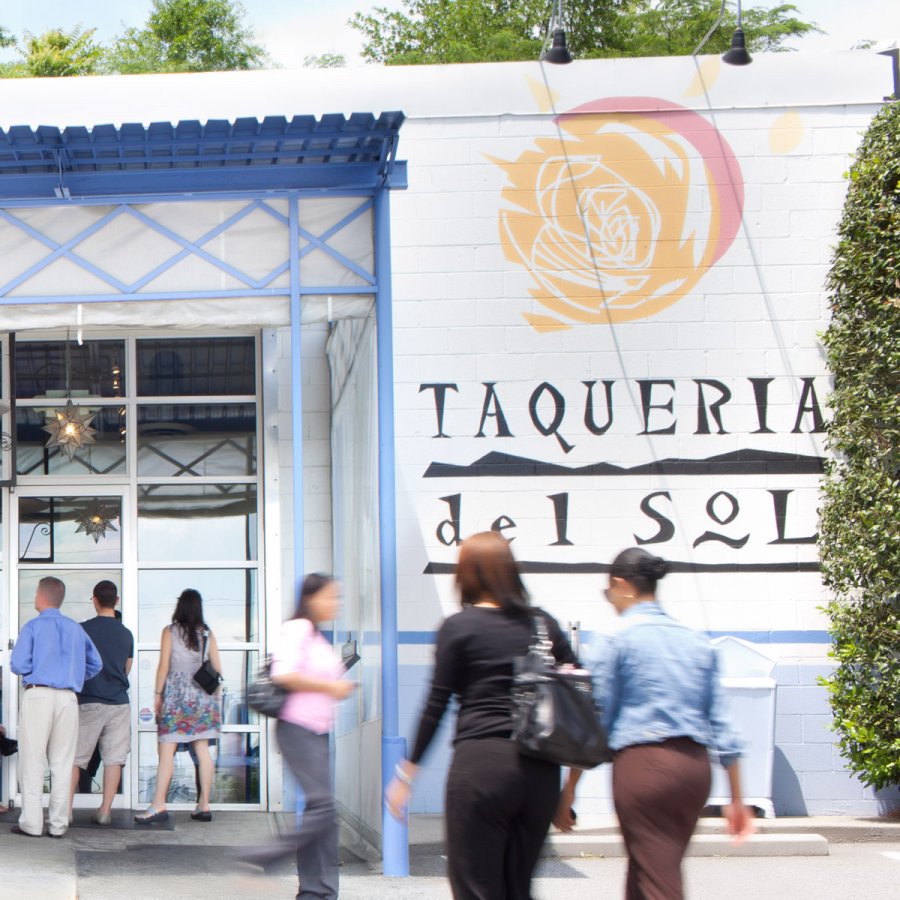 Taqueria del Sol restaurant facade with patrons in foreground