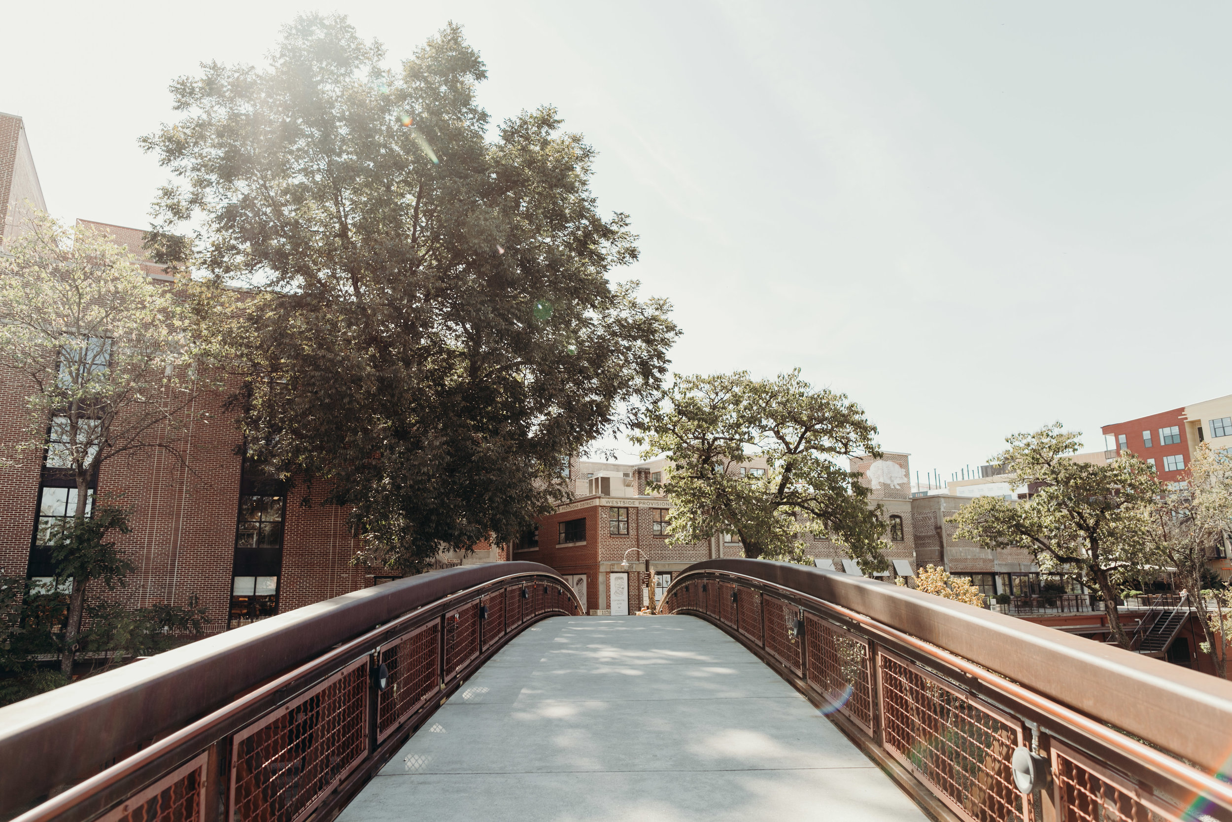 Pedestrian footbridge with storefronts in background