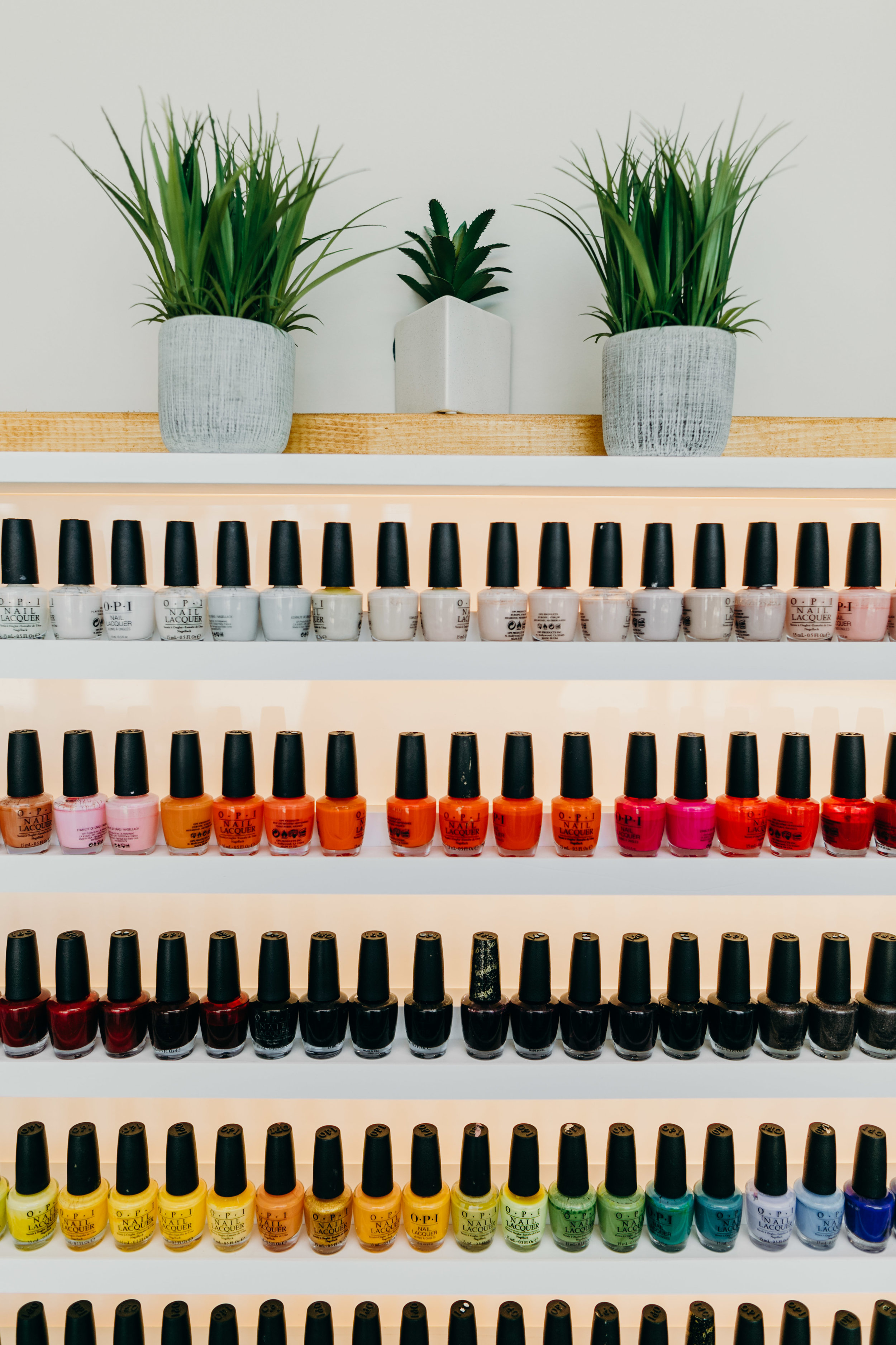 Retail display of multicolored nail polish bottles at Nouvelle Nails