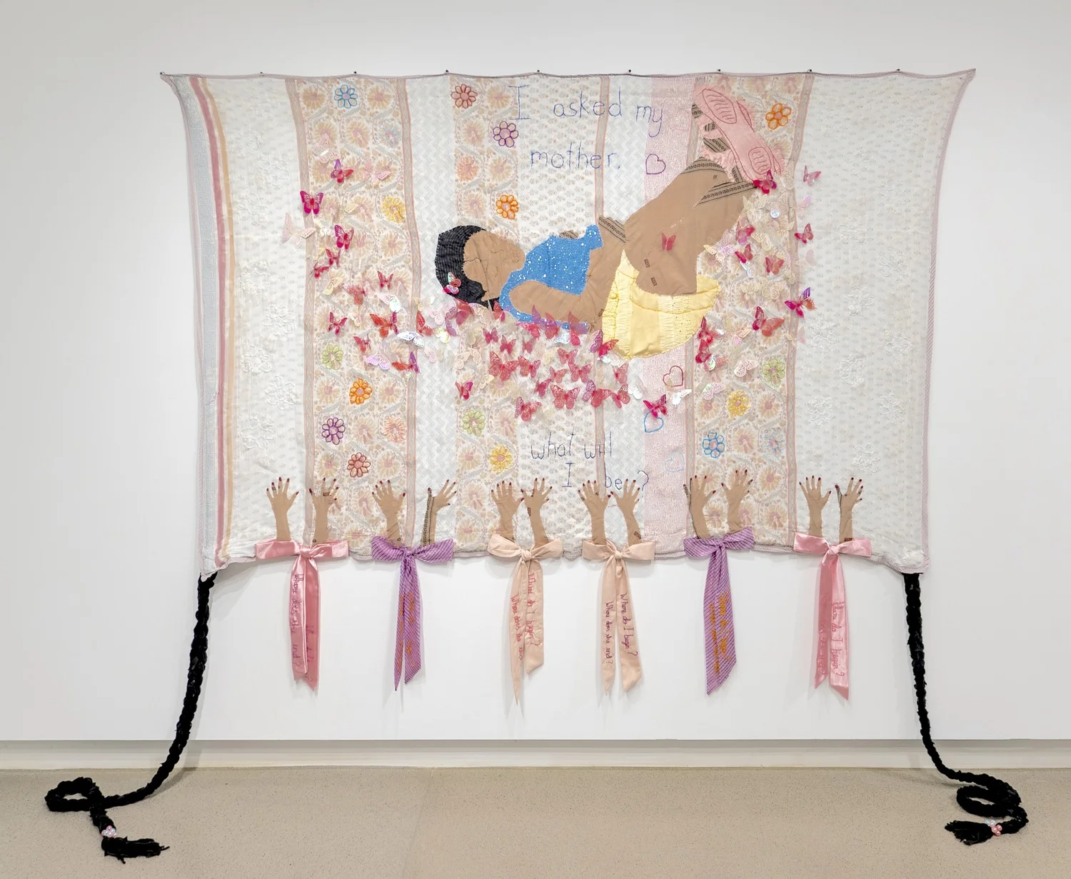 Reevah Agarwaal’s pink textile work Will I be free?, featuring a child in a blue dress and two long braids.