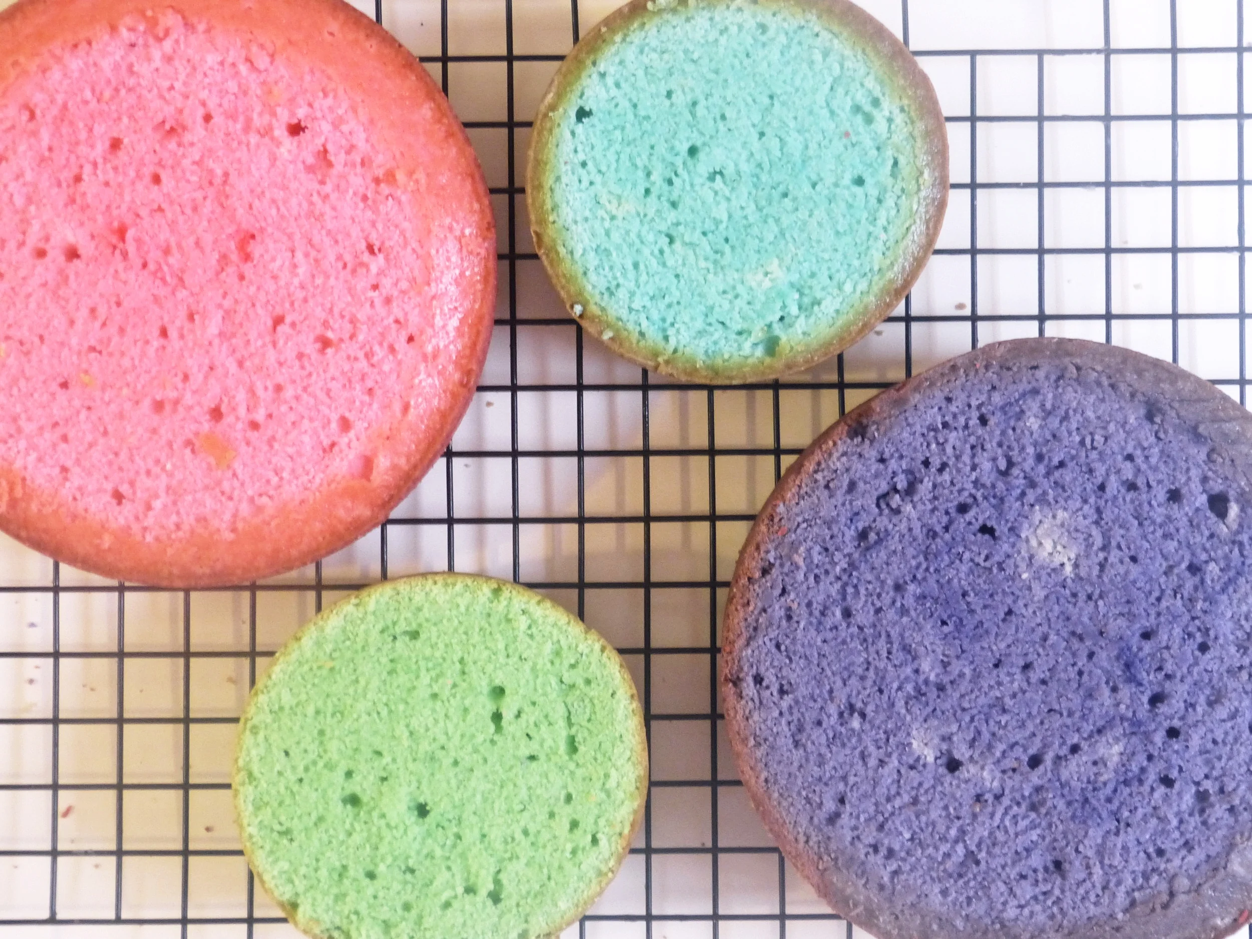 Once your cakes are cooled, using a large serrated knife or a cake leveler to level your cakes. I used two six inch pans and 2 four inch pans. Each was leveled to about 1 1/4 inches tall.