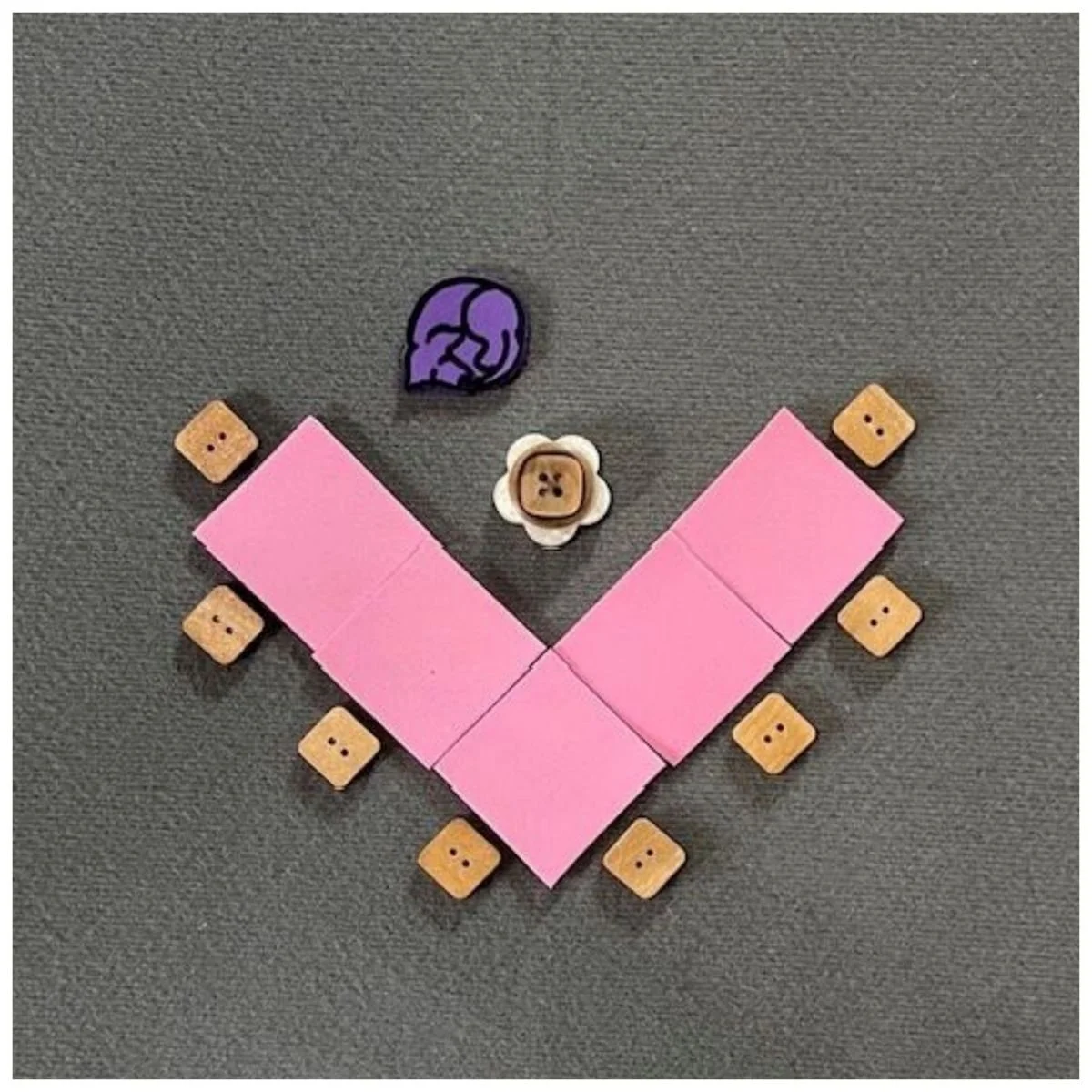 Pink rectangles representing tables set in a v-shape. Chairs on the outside of the "V" for attendees and a rolling chair and guide dog will be on the opposite side than the attendees.