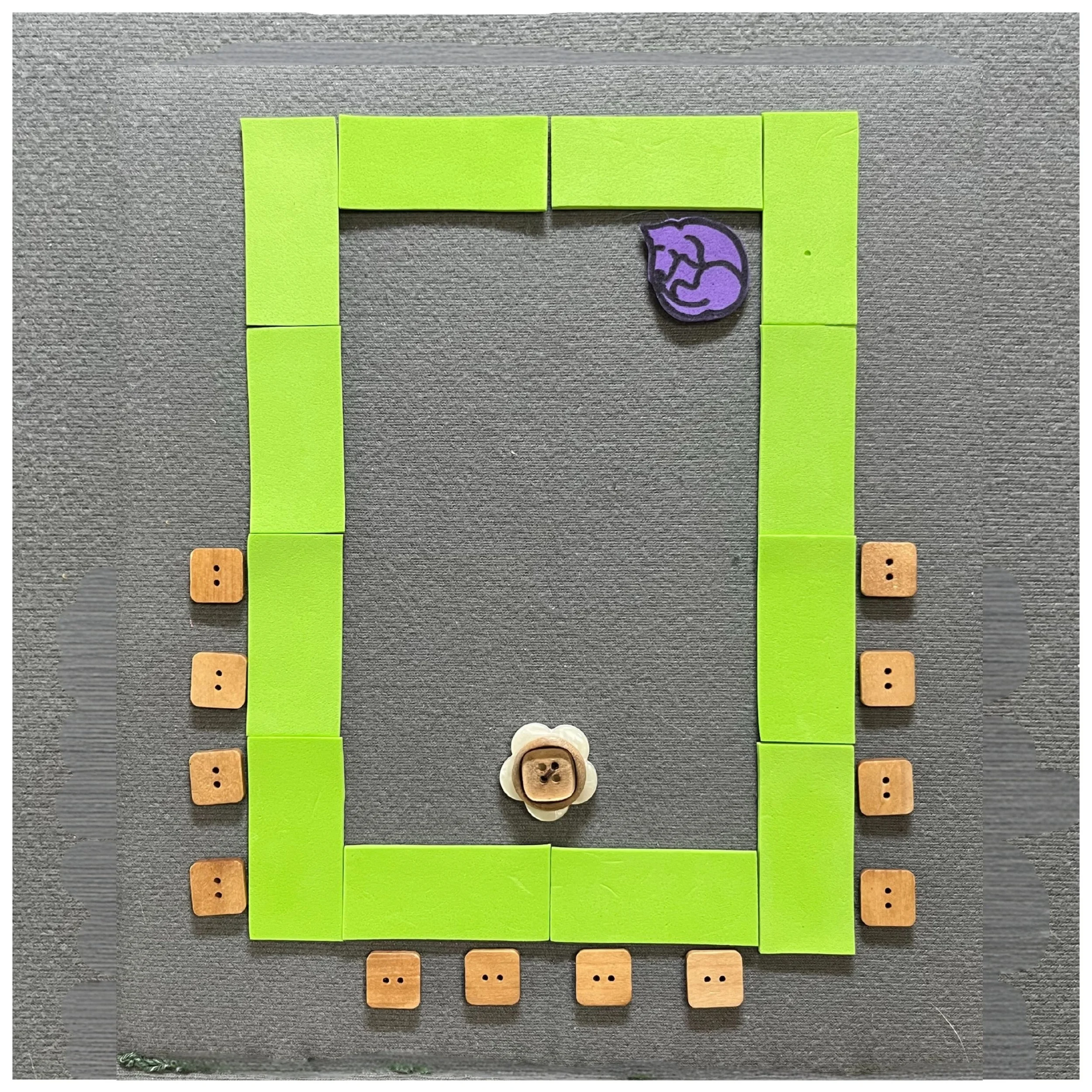 Rectangular tables arranged in a hollow square (rectangle open in the middle) with chairs around the outside at one end.