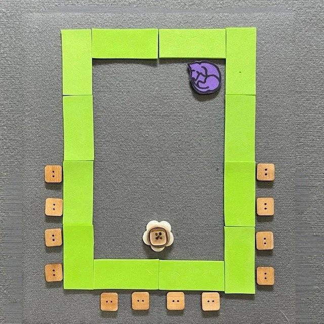 Green shapes represent tables. They are configured in a hollow square. Chairs are place on the outside at one end, in the shape of U or a V. Icons representing a rolling chair and a guide dog are in the hollow center.