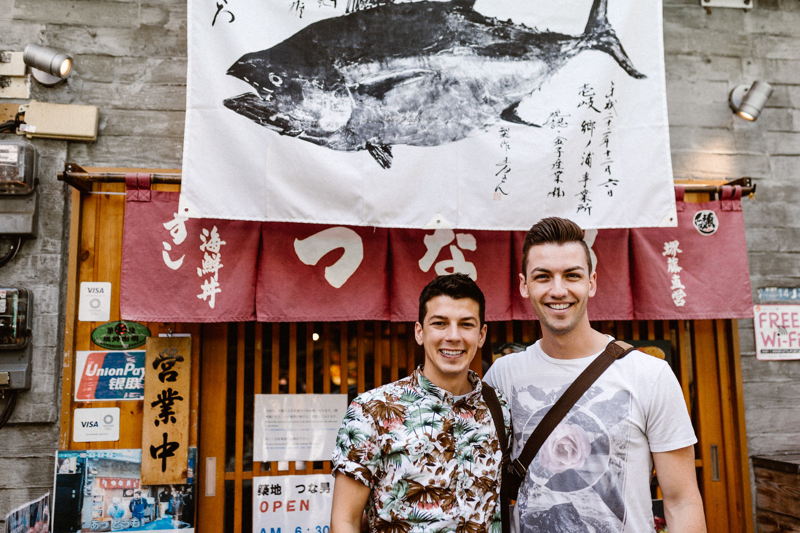 Matthew and Michael gay husbands in front of sushi restaurant tsukiki market Tokyo Japan