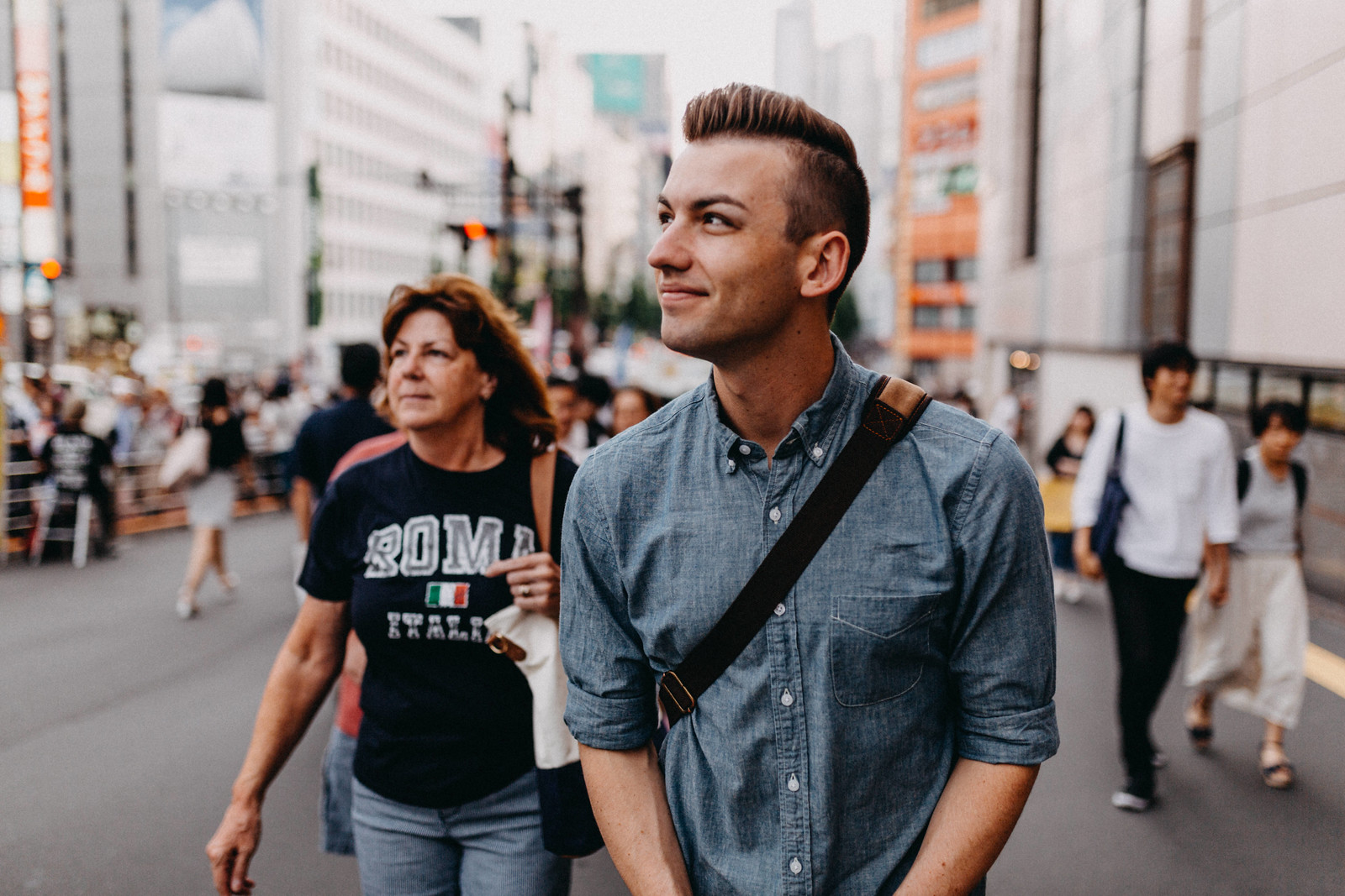 Gay backpacker and mom walking through Shinjuku on first visit to Tokyo Japan