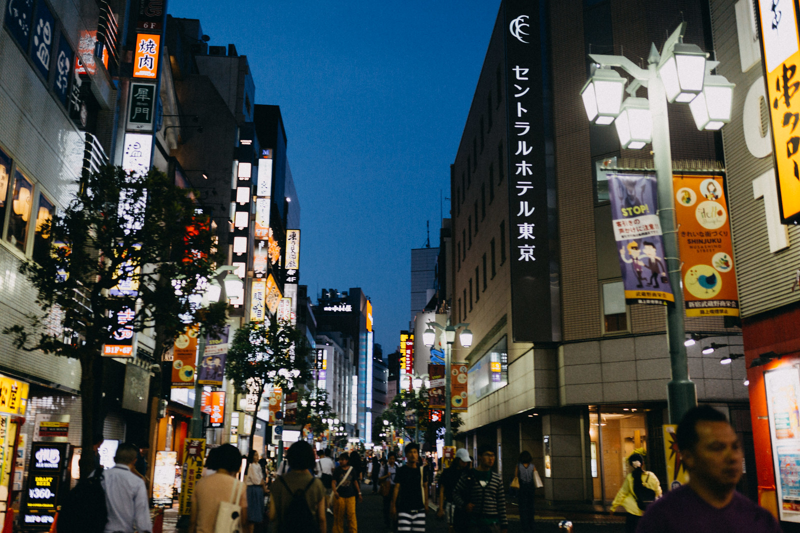 Lots of people in crowded shinjuku street experiencing night life