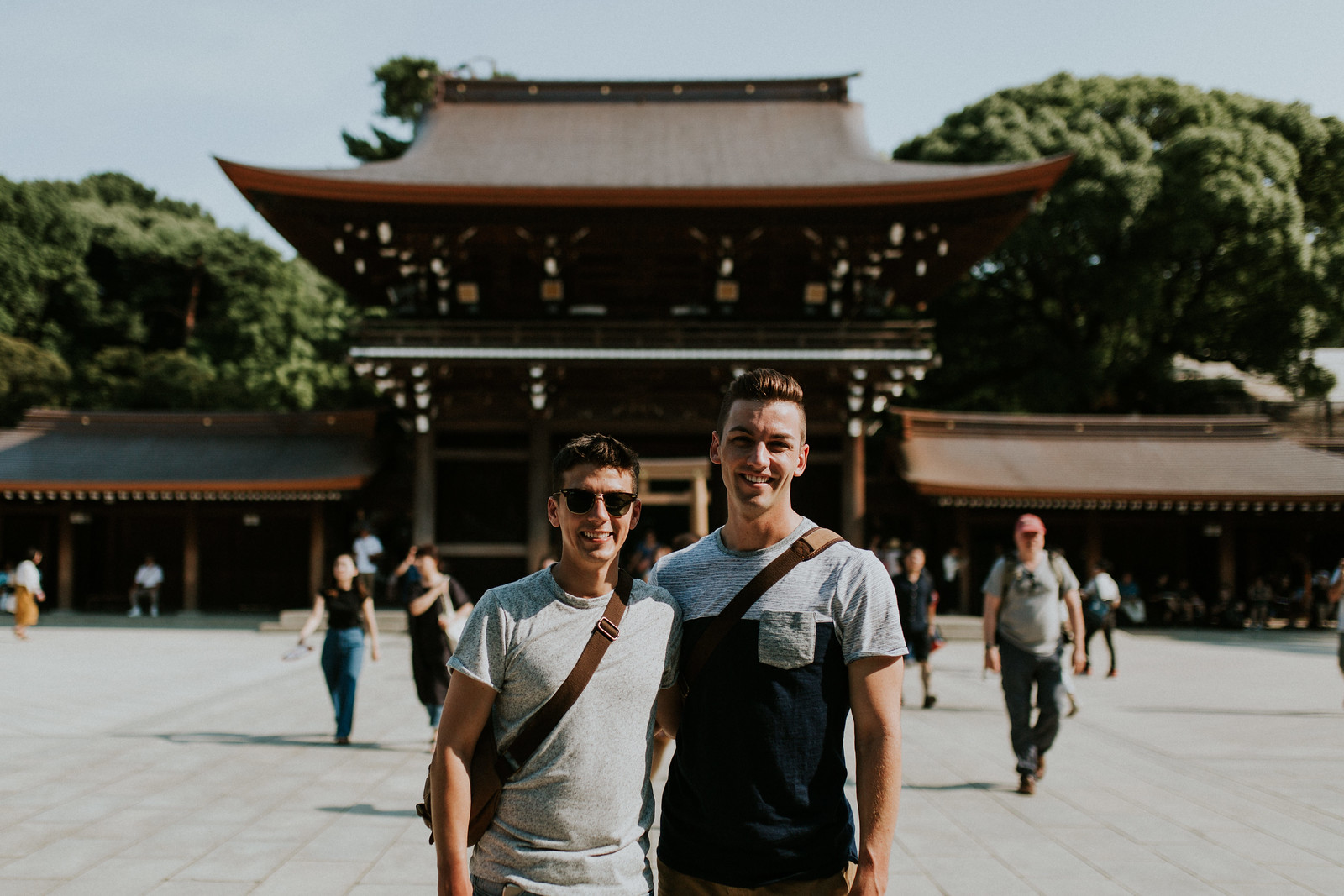 Gay backpackers lgbt husbands matthew and michael in Meiji Jingu Shrine in Yoyogi Park Tokyo Japan