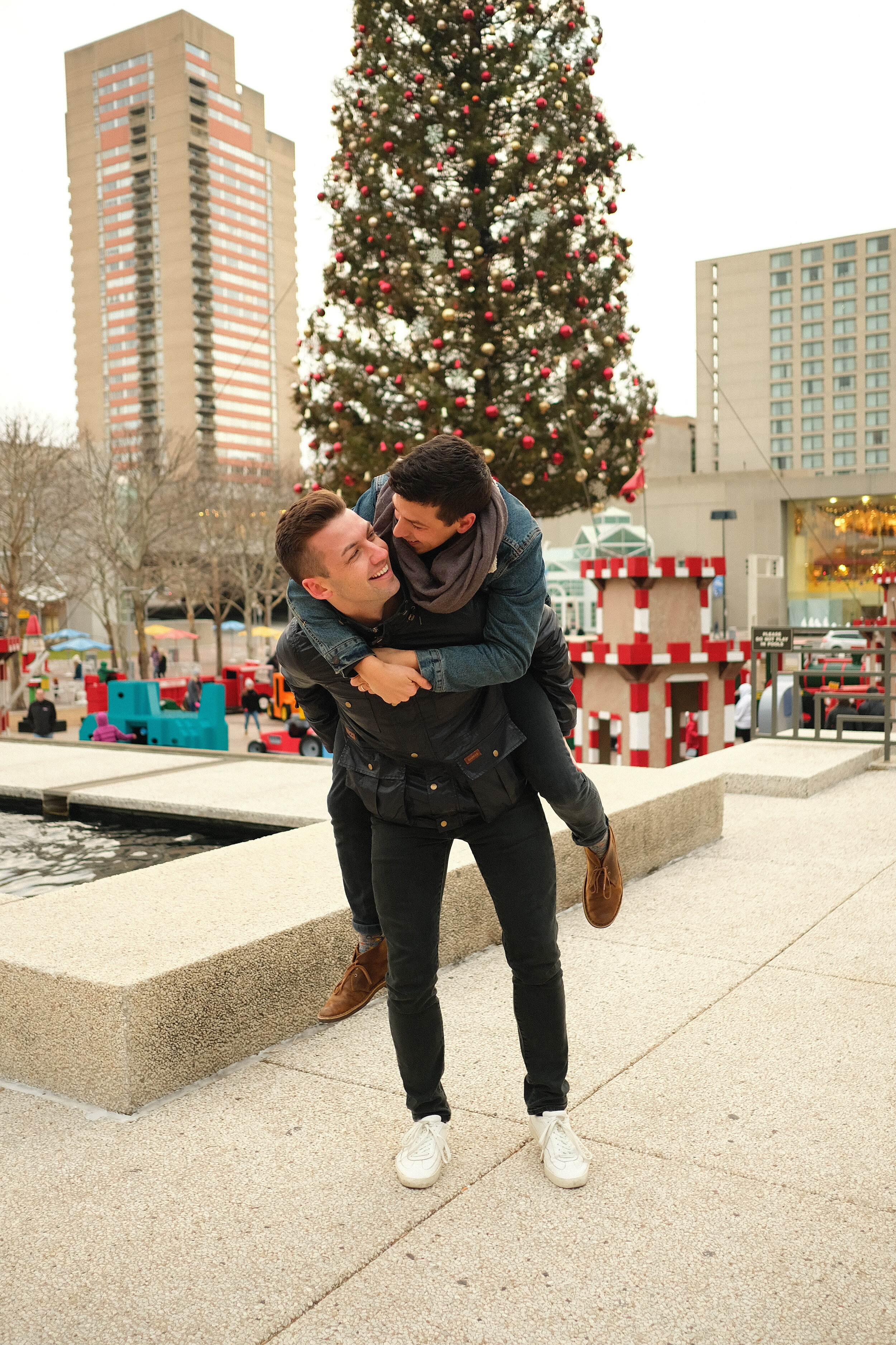 Gay couple embrace at Crown Center.JPG