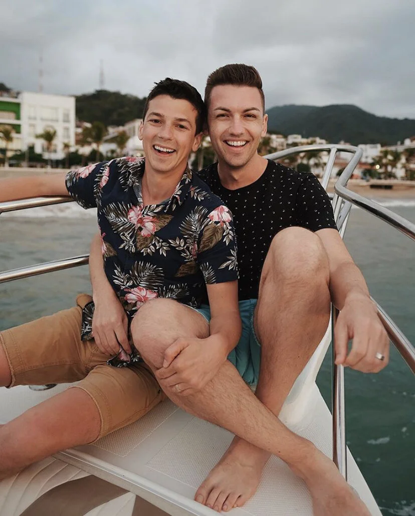 Michael and Matt smiling on the front of the boat