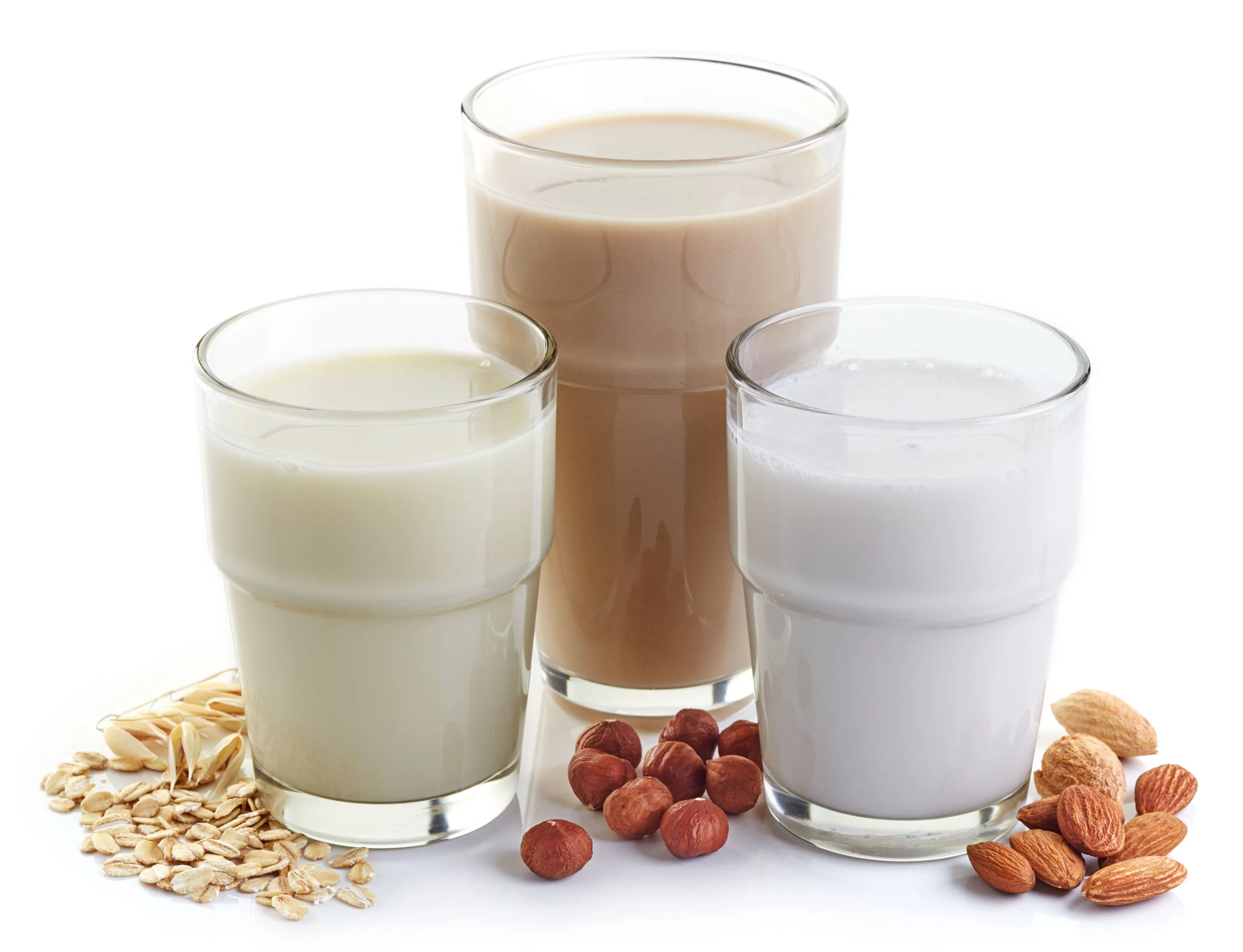 different vegan milk: almond milk, hazelnut milk and oat milk