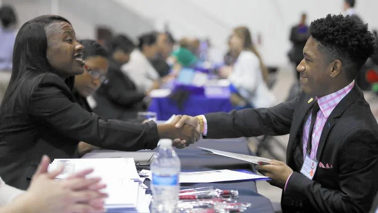 David Jeffries, a senior at Mather High School, shakes hands at the end of an interview with Northern Illinois University regional admissions counselor Christy Dorsey on Oct. 27, 2015, at the Chicago Scholars Foundation’s 9th annual Onsite Admissions Forum and Luncheon at Navy Pier in Chicago. (Jose M. Osorio / Chicago Tribune)