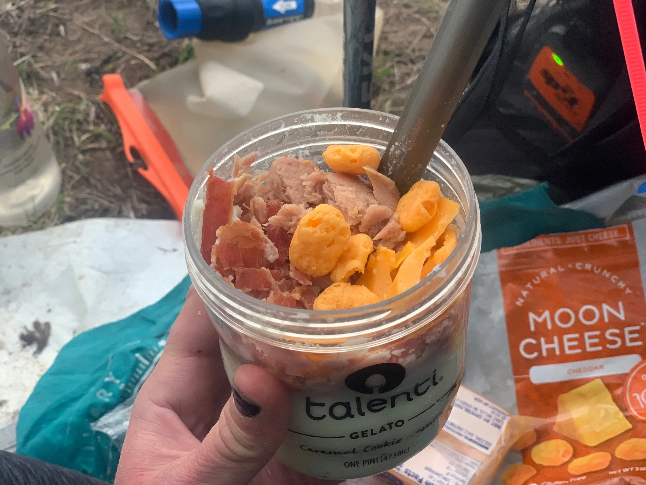 Cold-soak dinner of Idahoan potatoes, tuna, slices of cheddar cheese, Moon Cheese, and pre-cooked bacon.