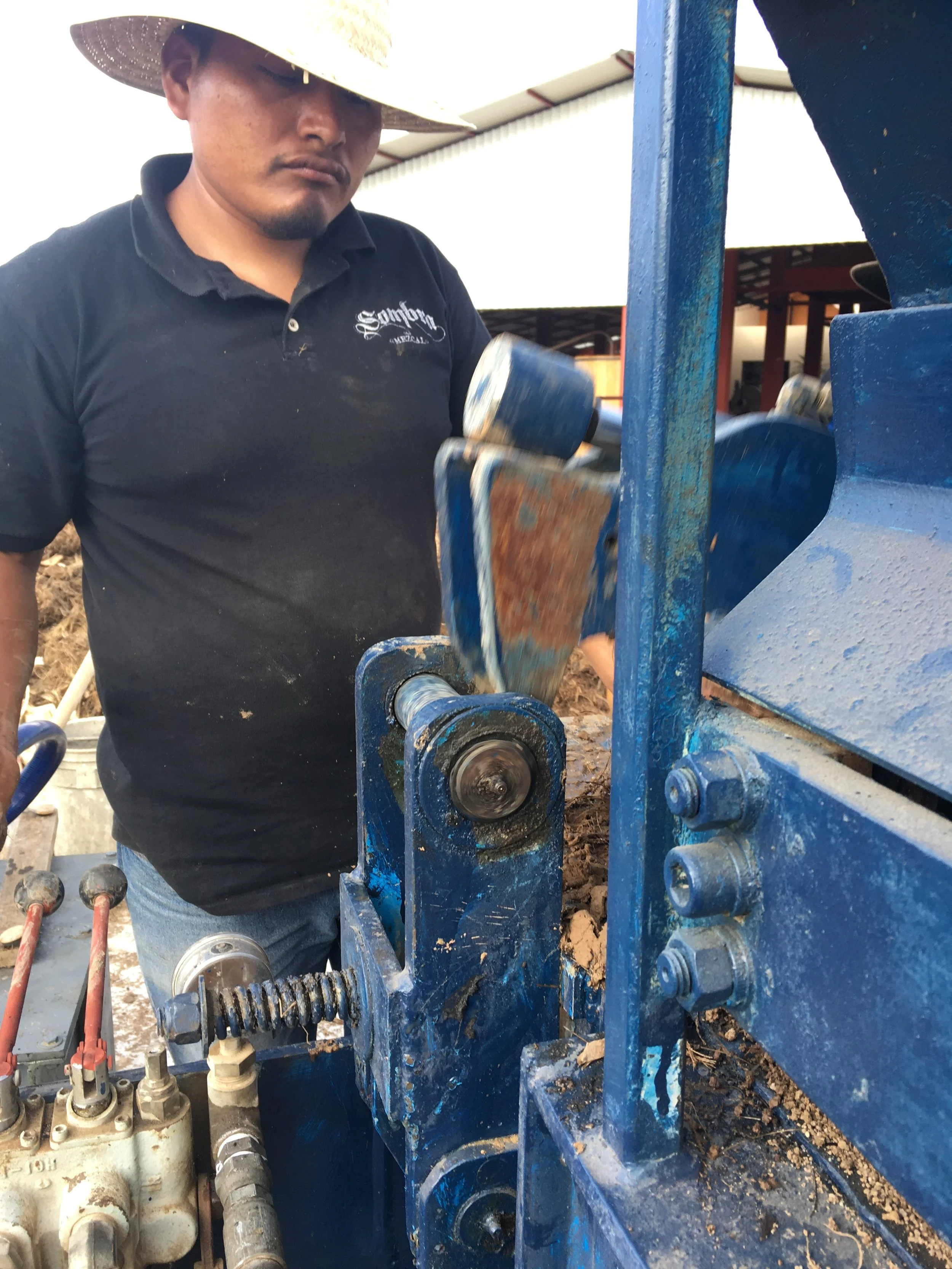  Miguel operating the adobe machine that can produce more than 500 bricks a day. 