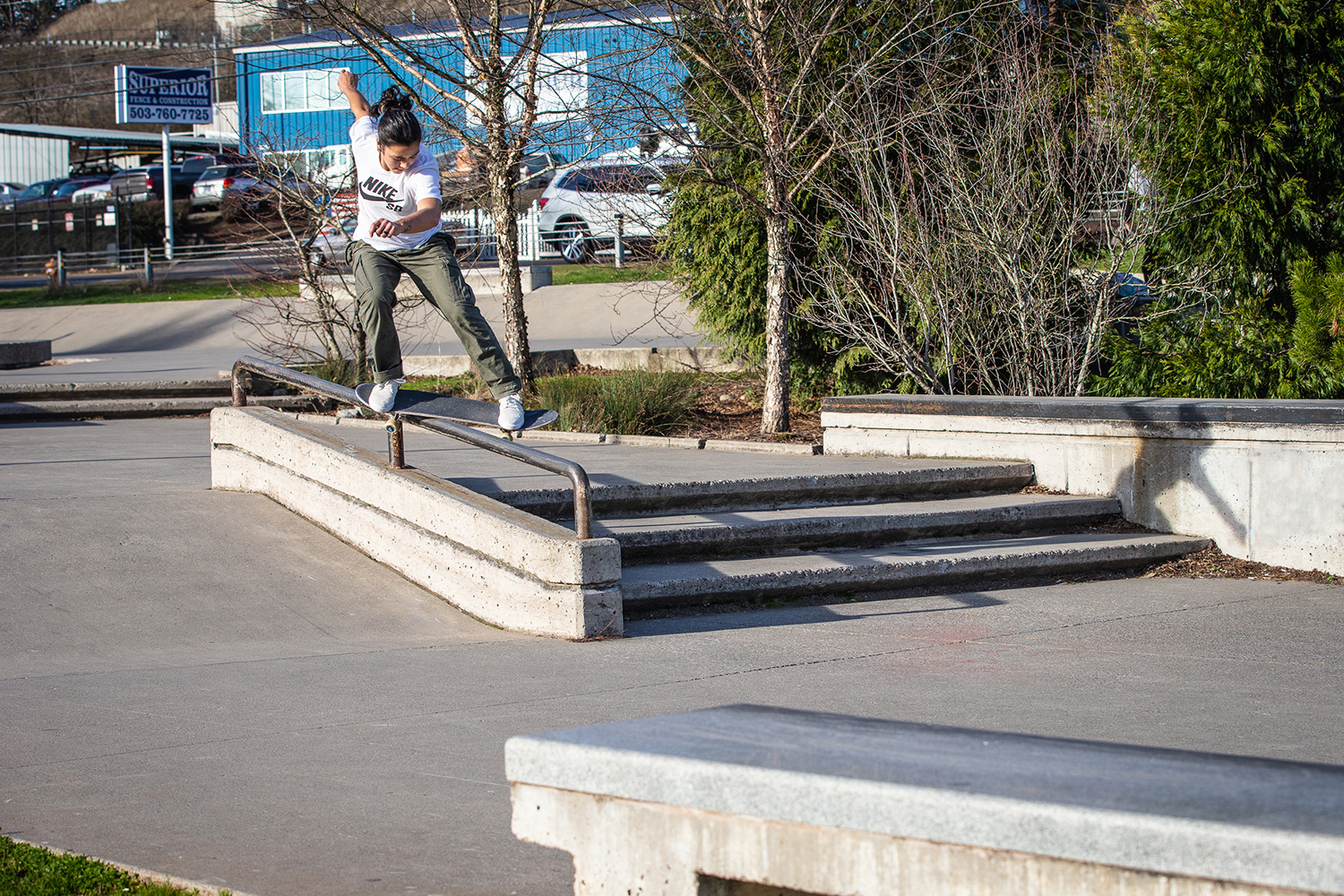  Proving that skateboarding is not just for the guys, Christiana Means feeble grinds one of the rails at Ed Benedict Skate Plaza. 