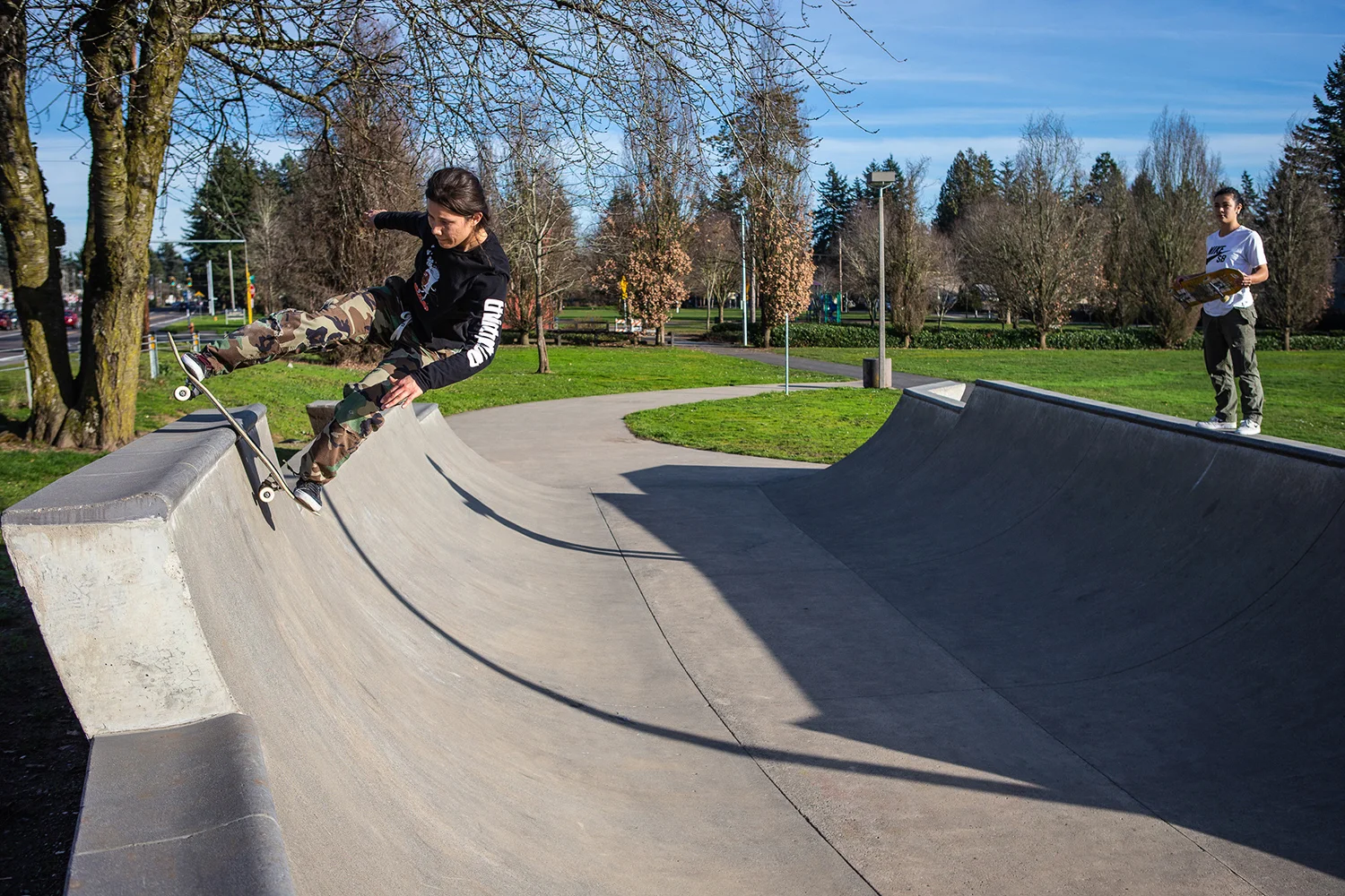 Micaela Profit rocks to fakie upon the pool block coping at Ed Benedict Skate Plaza.