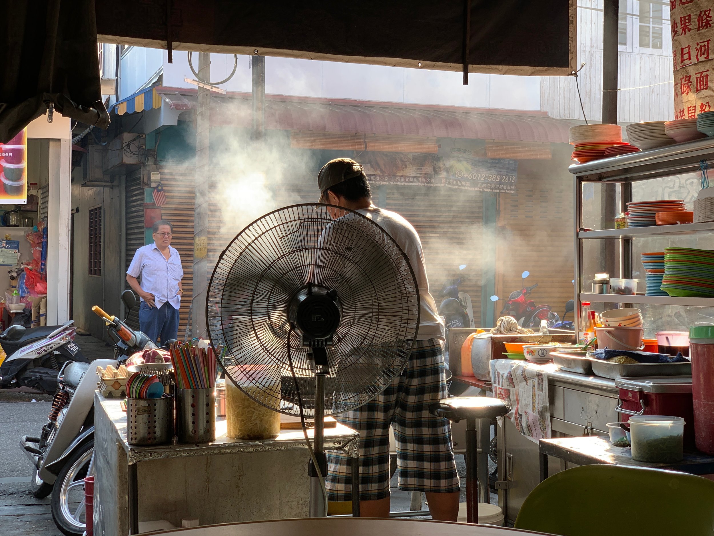 Keeping cool while cooking at one of the breakfast food stalls