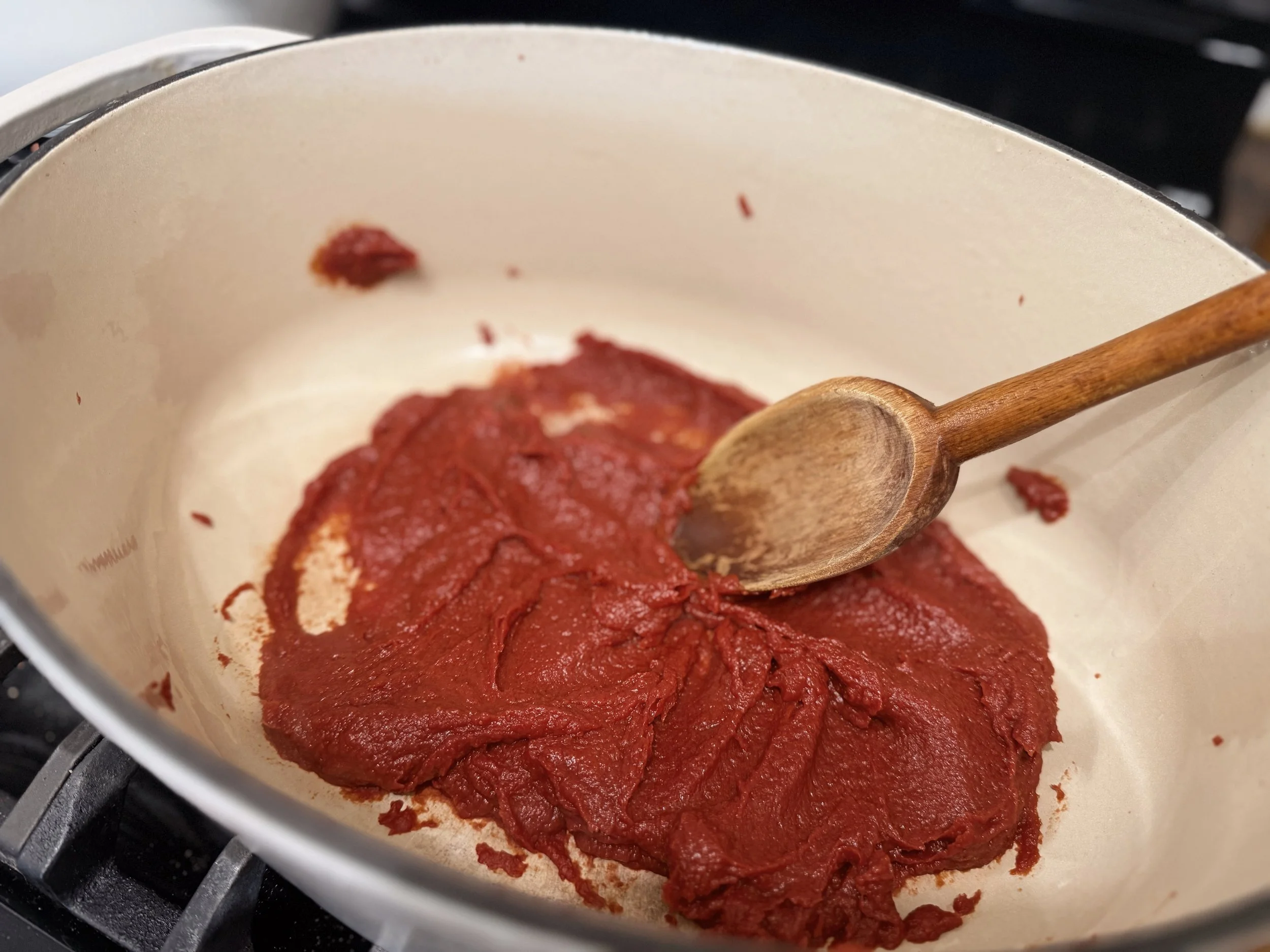 Simmer tomato paste over medium heat
