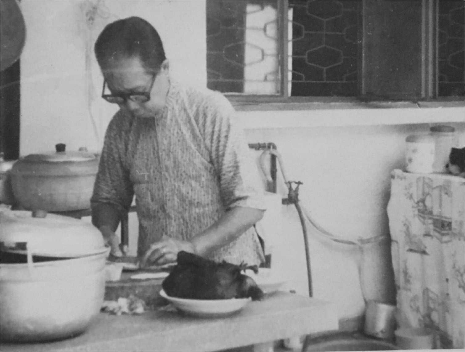 Auyong Foon preparing food in an outdoor kitchen