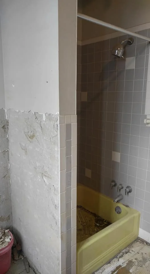 The old dark shower - complete with a very heavy tiny cast iron yellow tub.