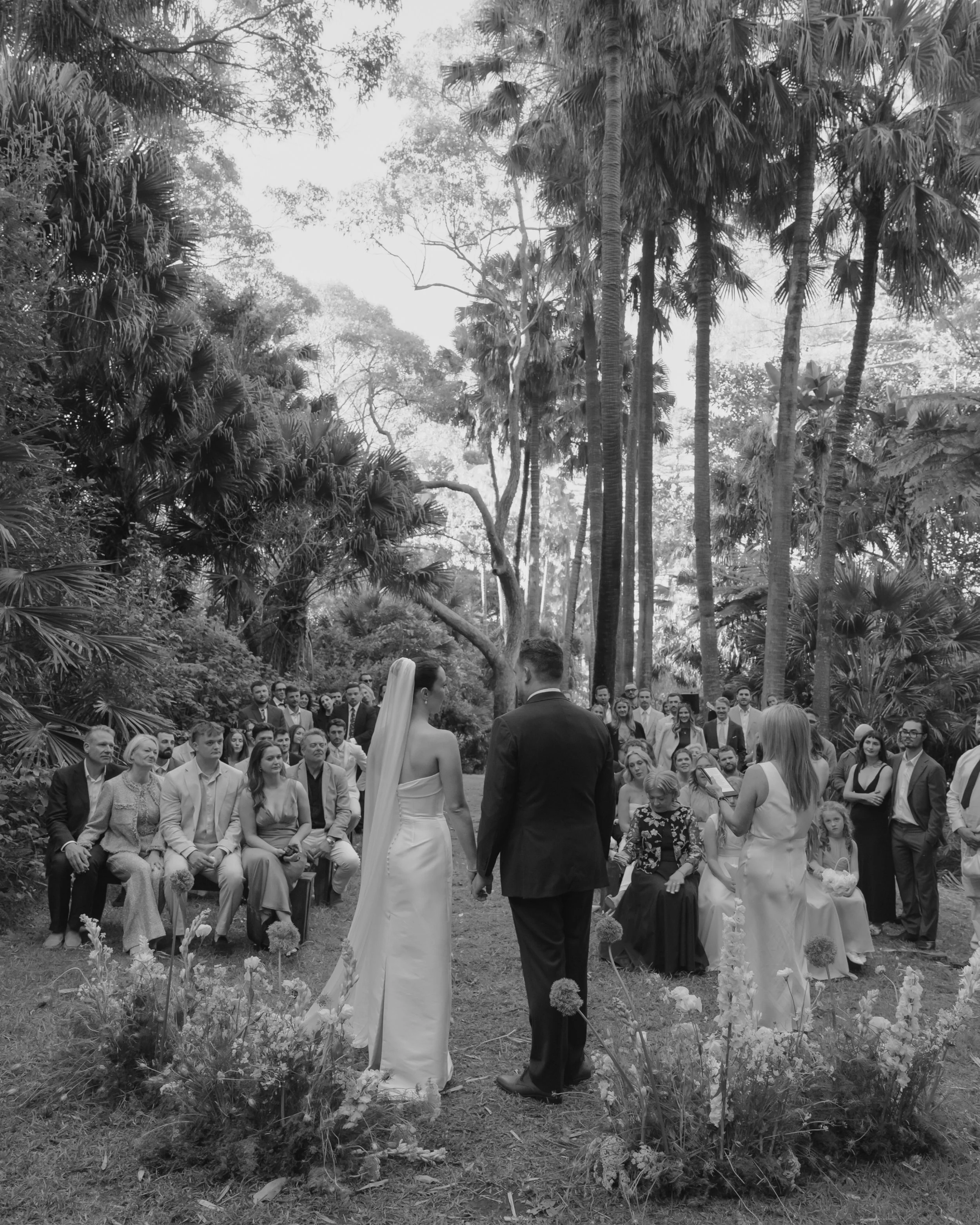 Molly &amp; Dylan wed in a magical grove in Palm Beach, surrounded by lush ferns, layered foliage, and every shade of green. It felt like stepping into a hidden garden before the celebration unfolded into an elegant reception at Dunes Palm Beach. A d