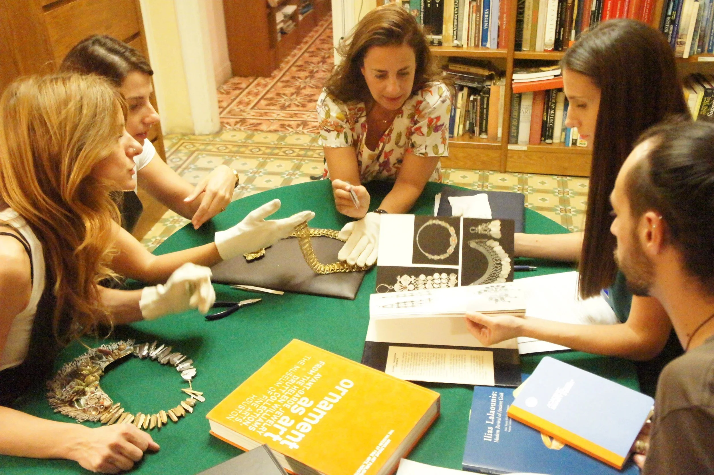 Curatorial interns studying jewelry from the museum's collection