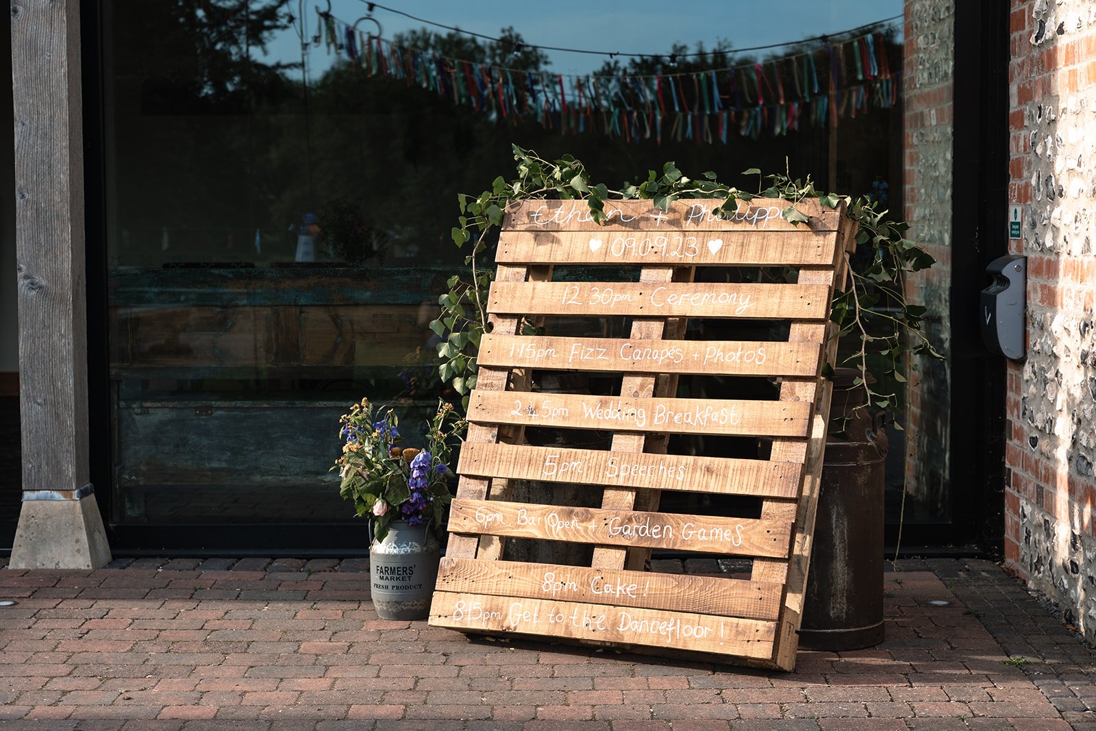 Wedding order of the day sign creatively painted on a pallet rack