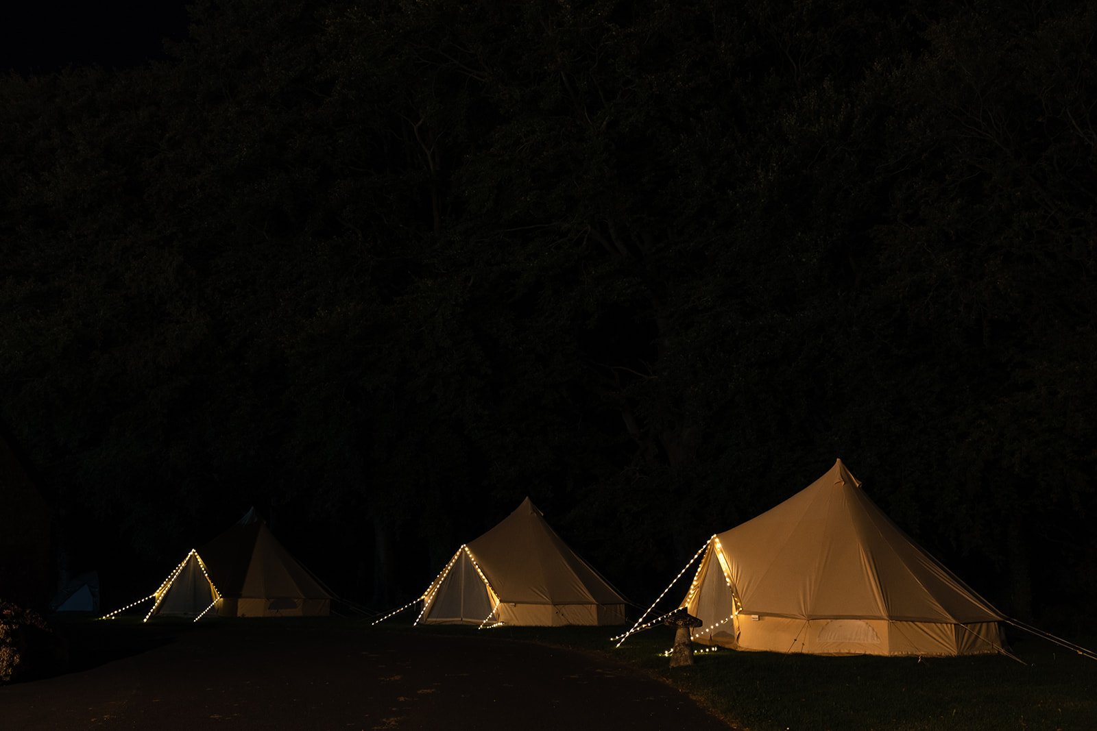 Illuminated bell tents in the dark