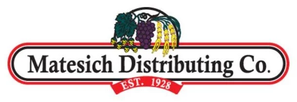 Logo of Matesich Distributing Co., established in 1928, with grapes, bananas, and other fruit graphic.