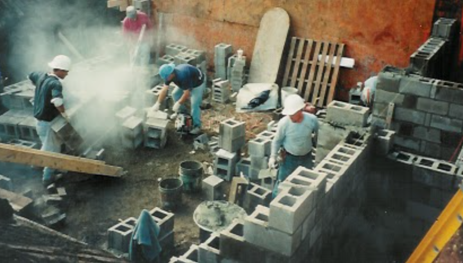 Construction workers engaged in building the basement of The Davis-Shai House at it's new location in Heath, Ohio.