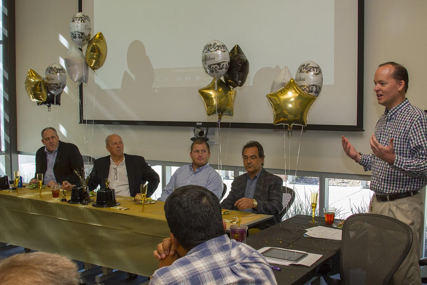 CEI Executive Director Jeff Saville celebrates the ECM team and the incubator company's achievement of one million dollars in revenue