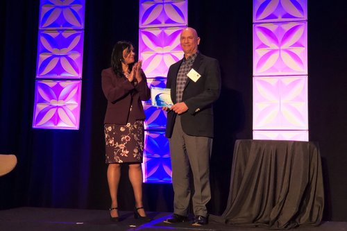 Tom Schumann, CEI Executive Director, accepting the award in Minneapolis, MN at ICBI33 on April 16, 2019.