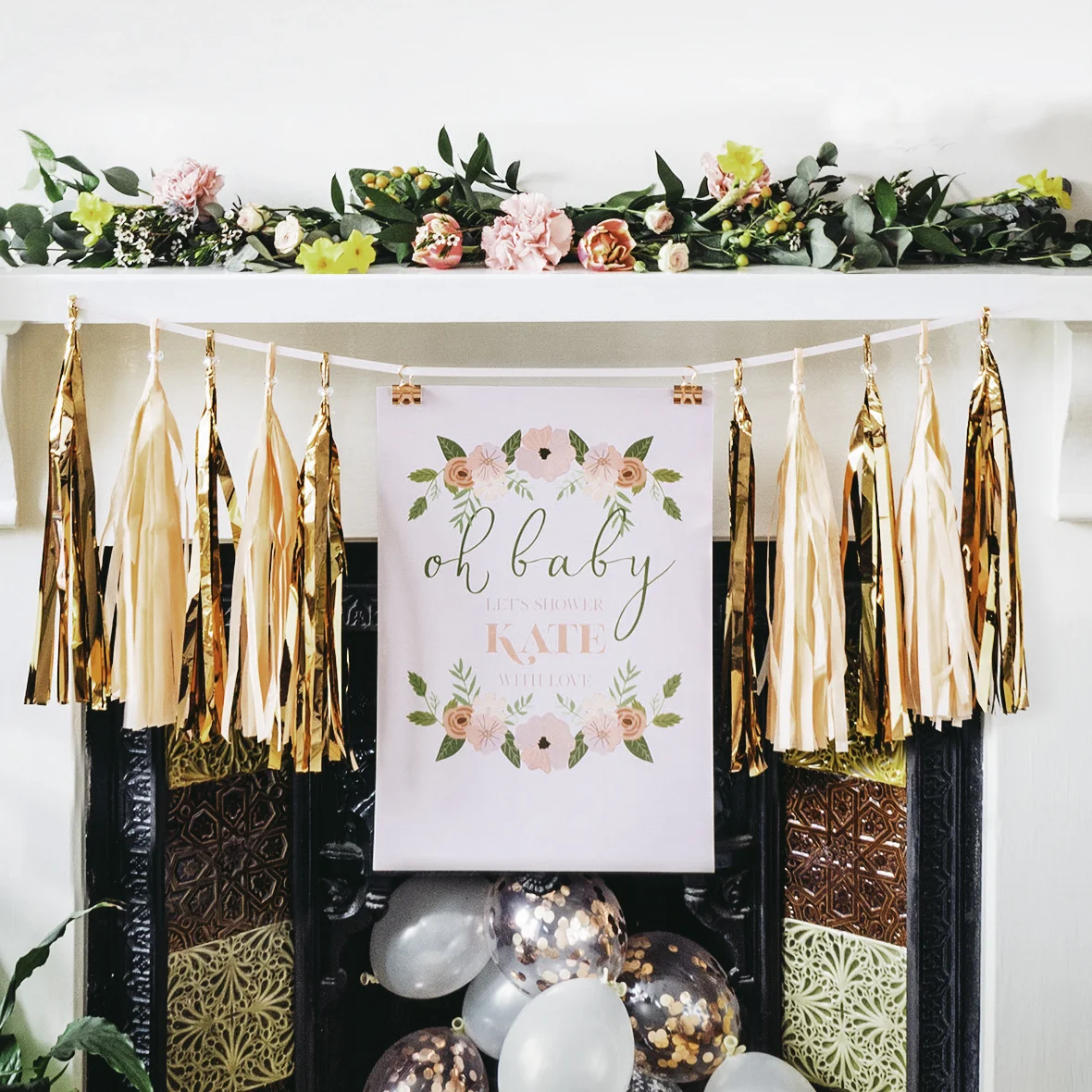 We hung a posters onto a length of ribbon using binder clips and used tassels from our tassel garlands at either side.