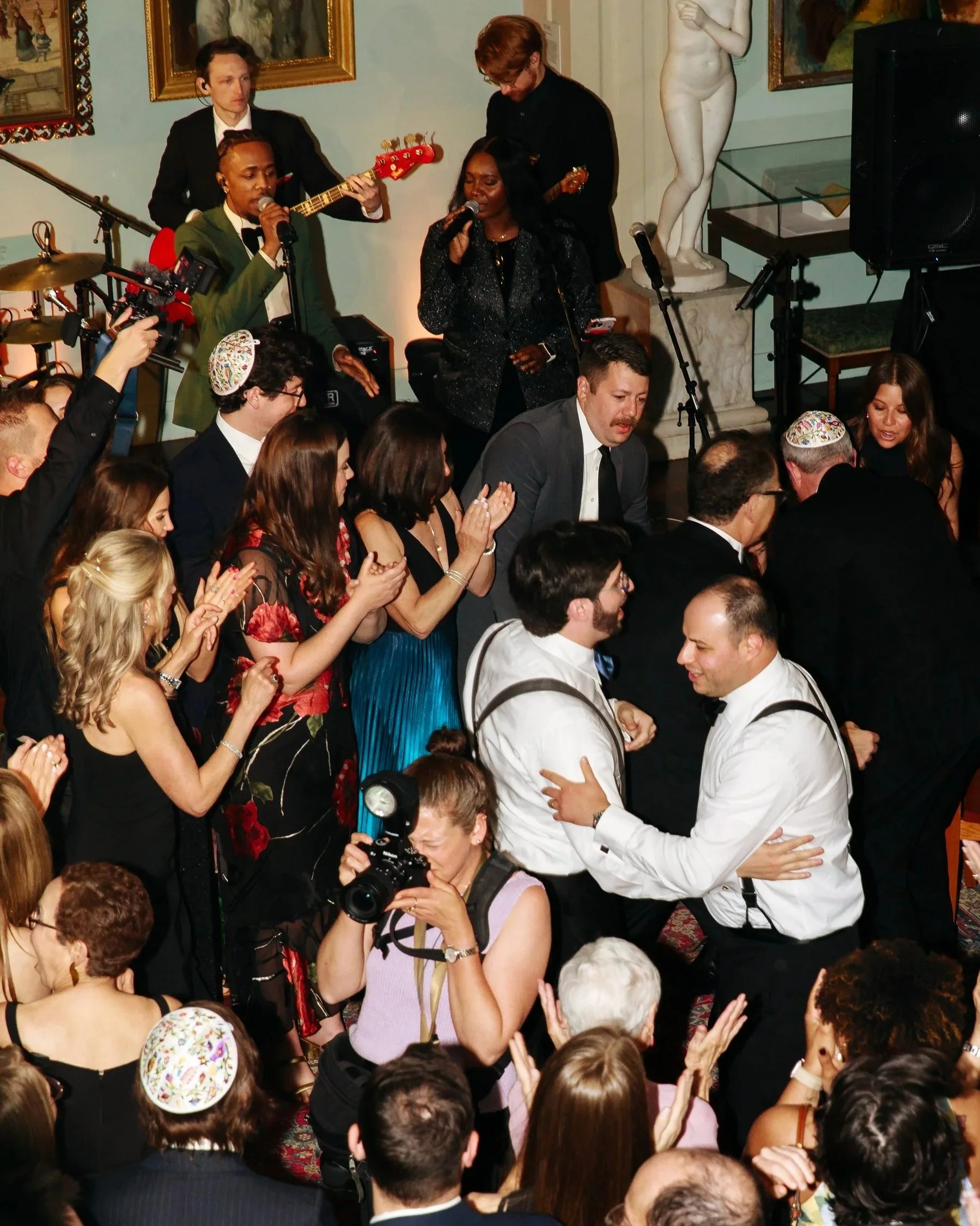 A photographer at work in the middle of a busy dance floor in a private library in Boston