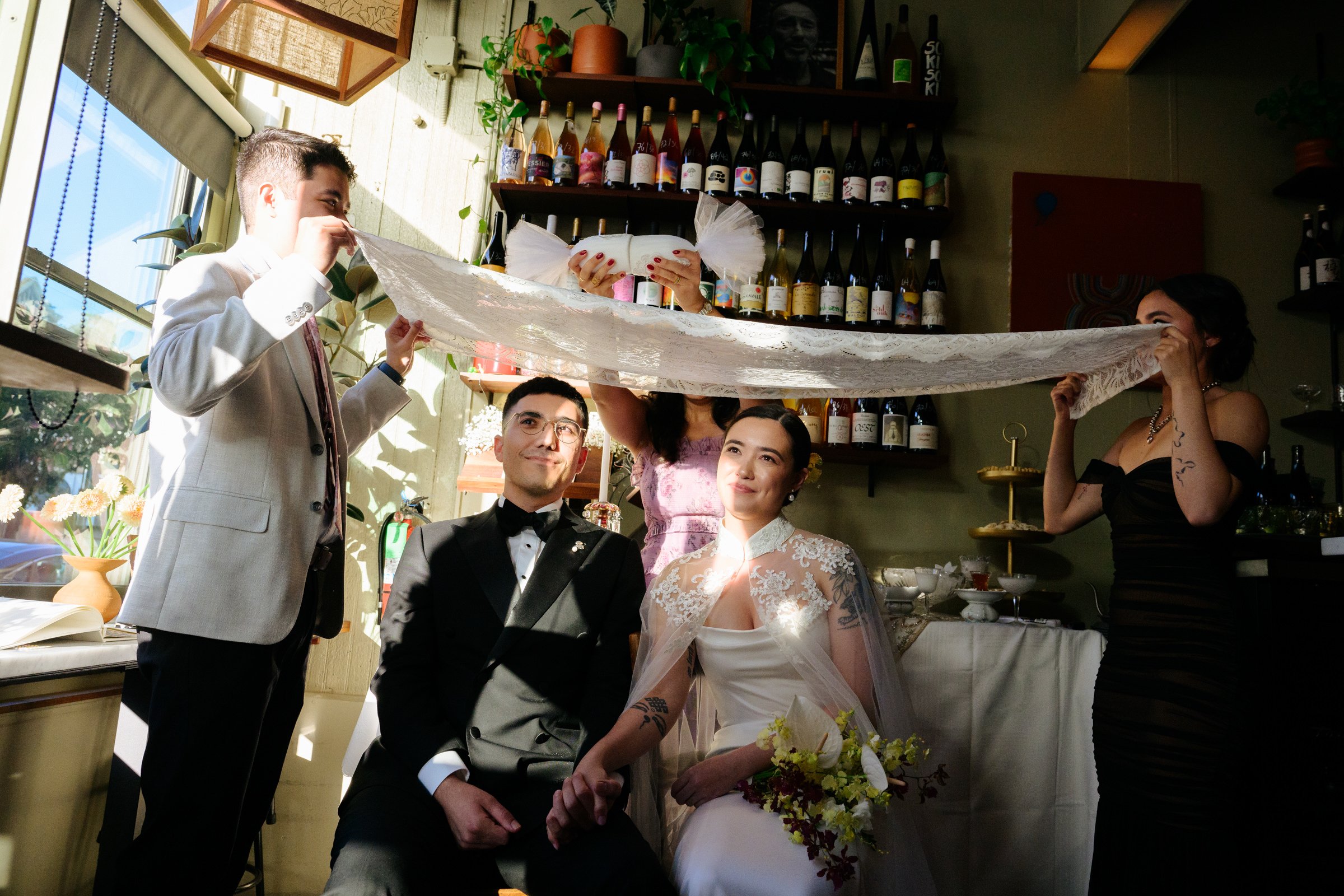 A couple getting married in the middle of a restaurant in the Mission. They are having an Aghd, with sugar rubbing.